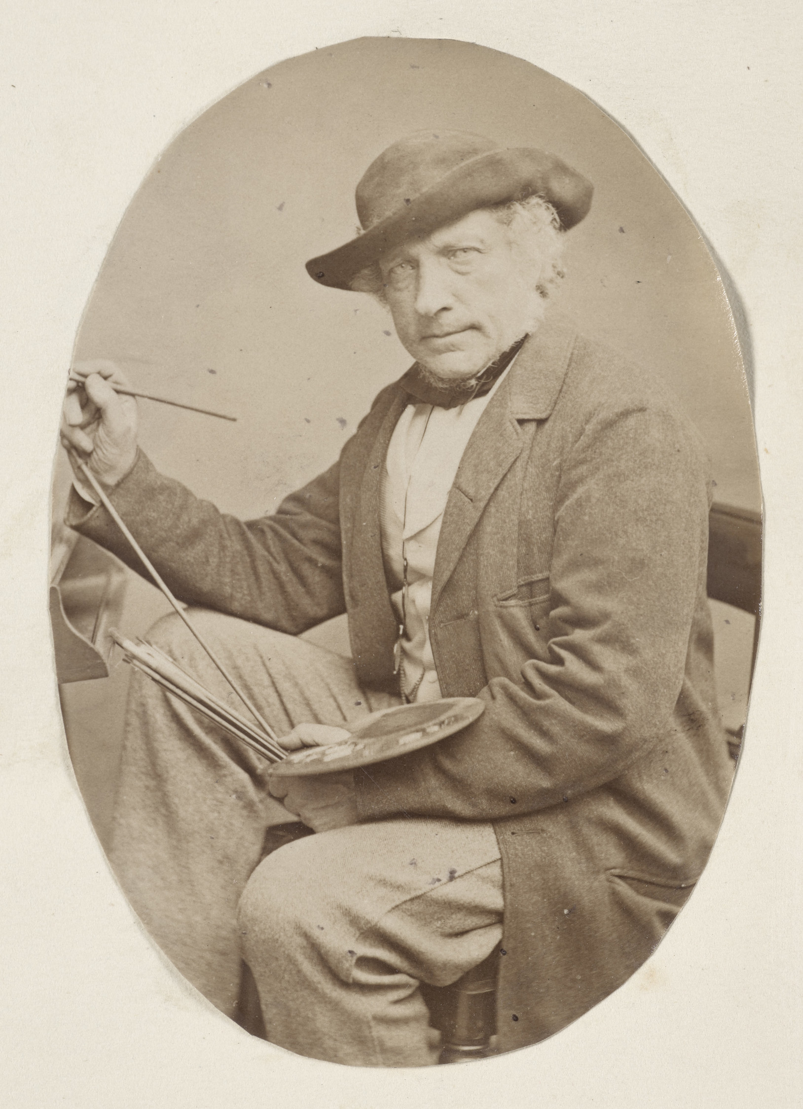 William Leighton Leitch (1804-83) Photograph of a three-quarters length portrait of William Leighton Leitch facing the viewer, wearing a long jacket and hat, sitting in front of an easel. A paint palette rests on his left arm and he holds a paintbrush in his right hand