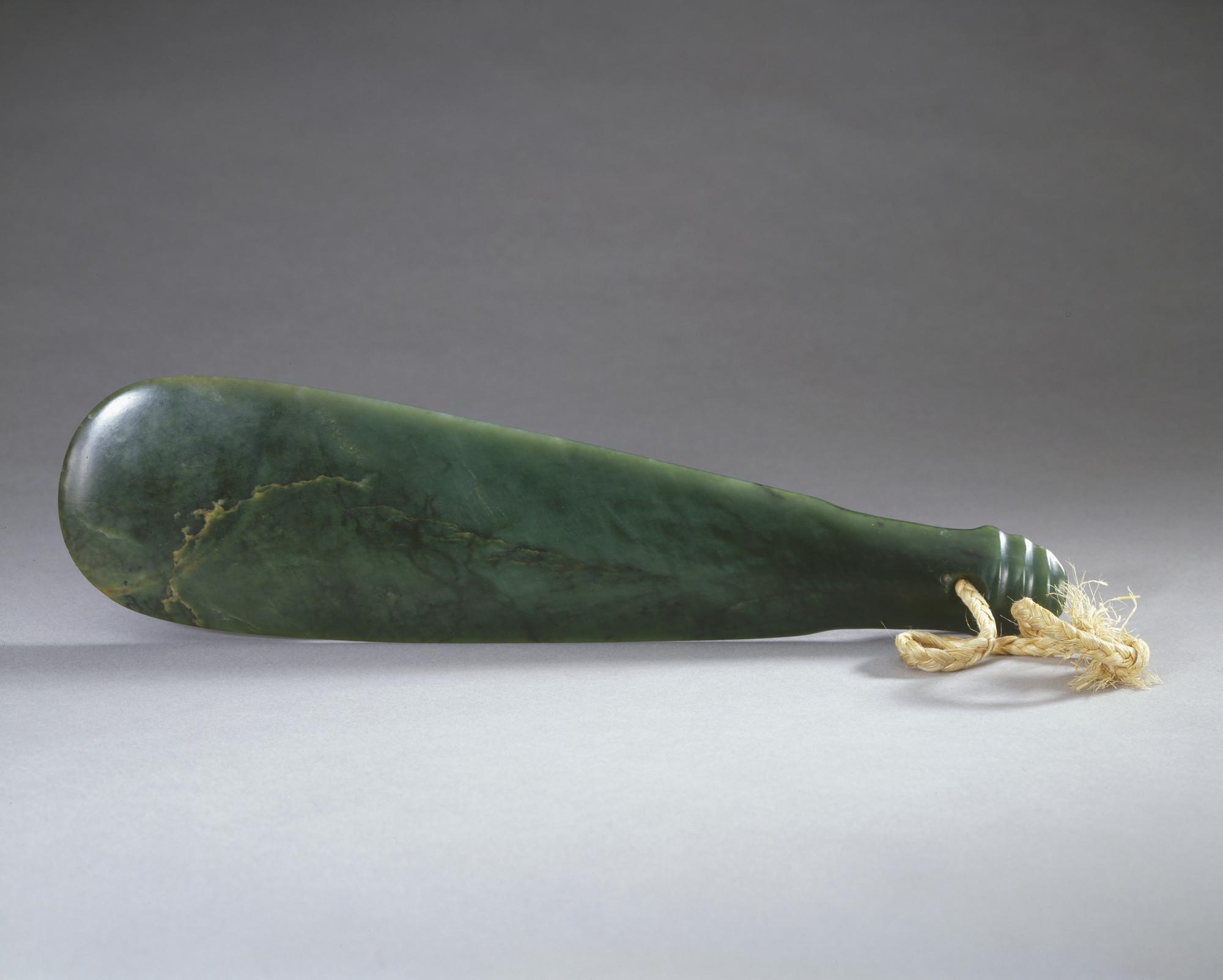 A Maori greenstone mere (flattened club-shaped weapon), pierced for a string handle. A mere is a hand club carried in a warrior's flax belt. It is a treasured heirloom, passed from generation to generation, and owned only by those Chiefs of highest standi