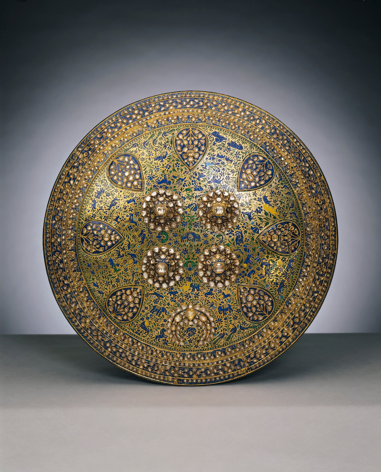 Dhal (shield) Like the weapons and other articles presented to Albert Edward Prince of Wales during his four-month tour of India in 1875-76, this is a particularly elaborate and rich example of a traditional form. Shields of this type, or dhal, were usually made of hid