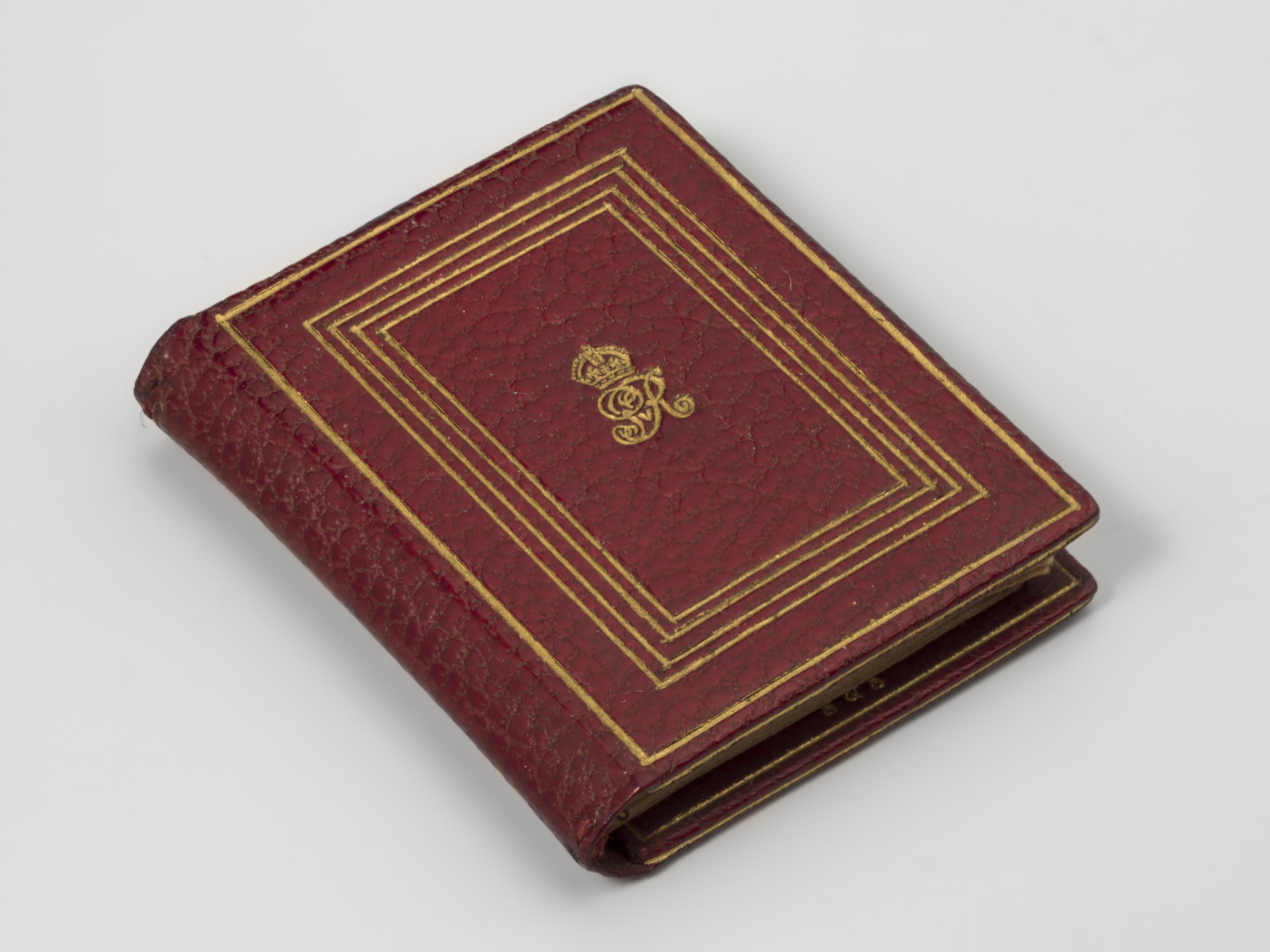 Miniature red leather blotter, tooled in gold with crowned GvR and plain line borders