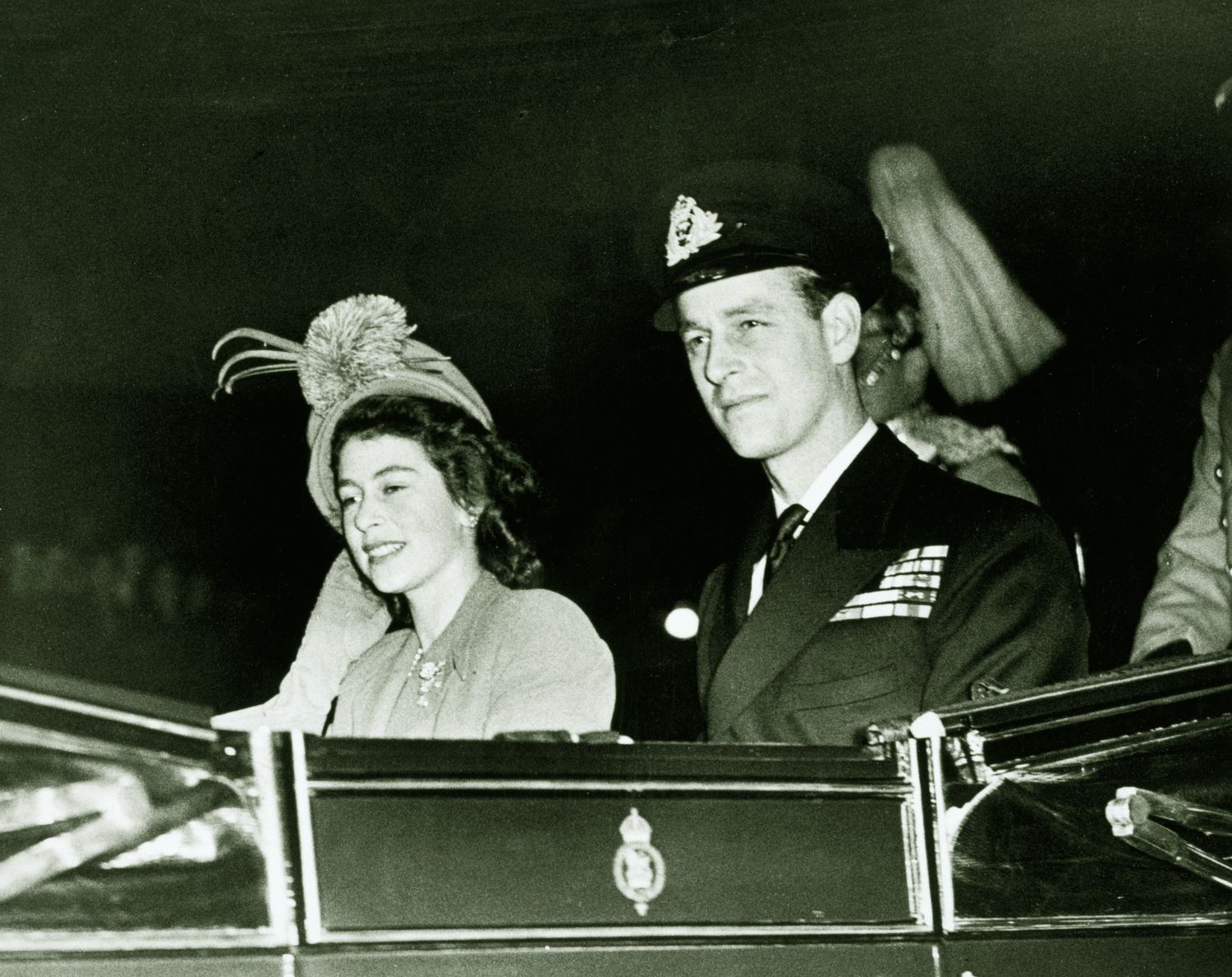 Photograph of Queen Elizabeth when Princess Elizabeth and The Duke of Edinburgh driving in an open carriage to Waterloo Station for the start of their honeymoon.