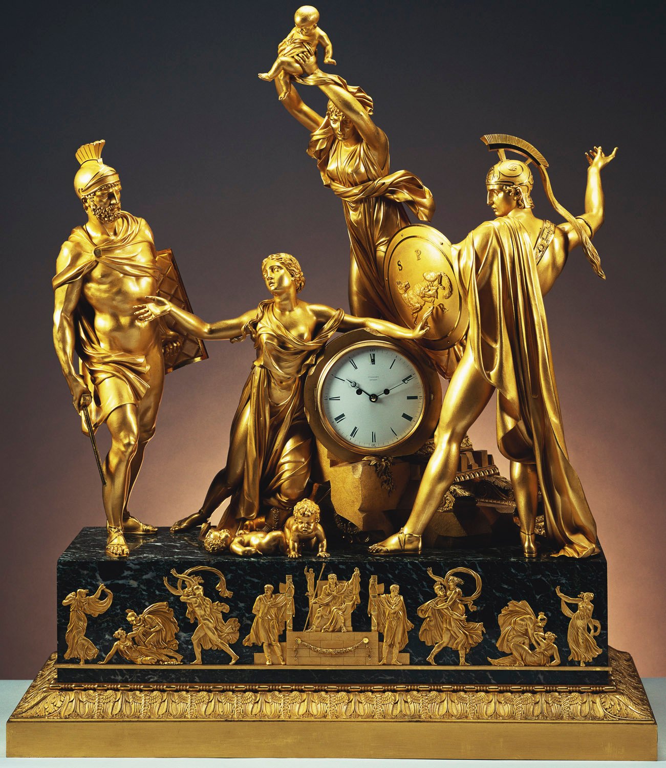 A mantel clock representing an incident in the struggle between the Sabines and the Romans and an interpretation of Jacques-Louis David's painting when the Sabine women intervene to reconcile the warring parties. Romulus, to the right, is poised to hurl h