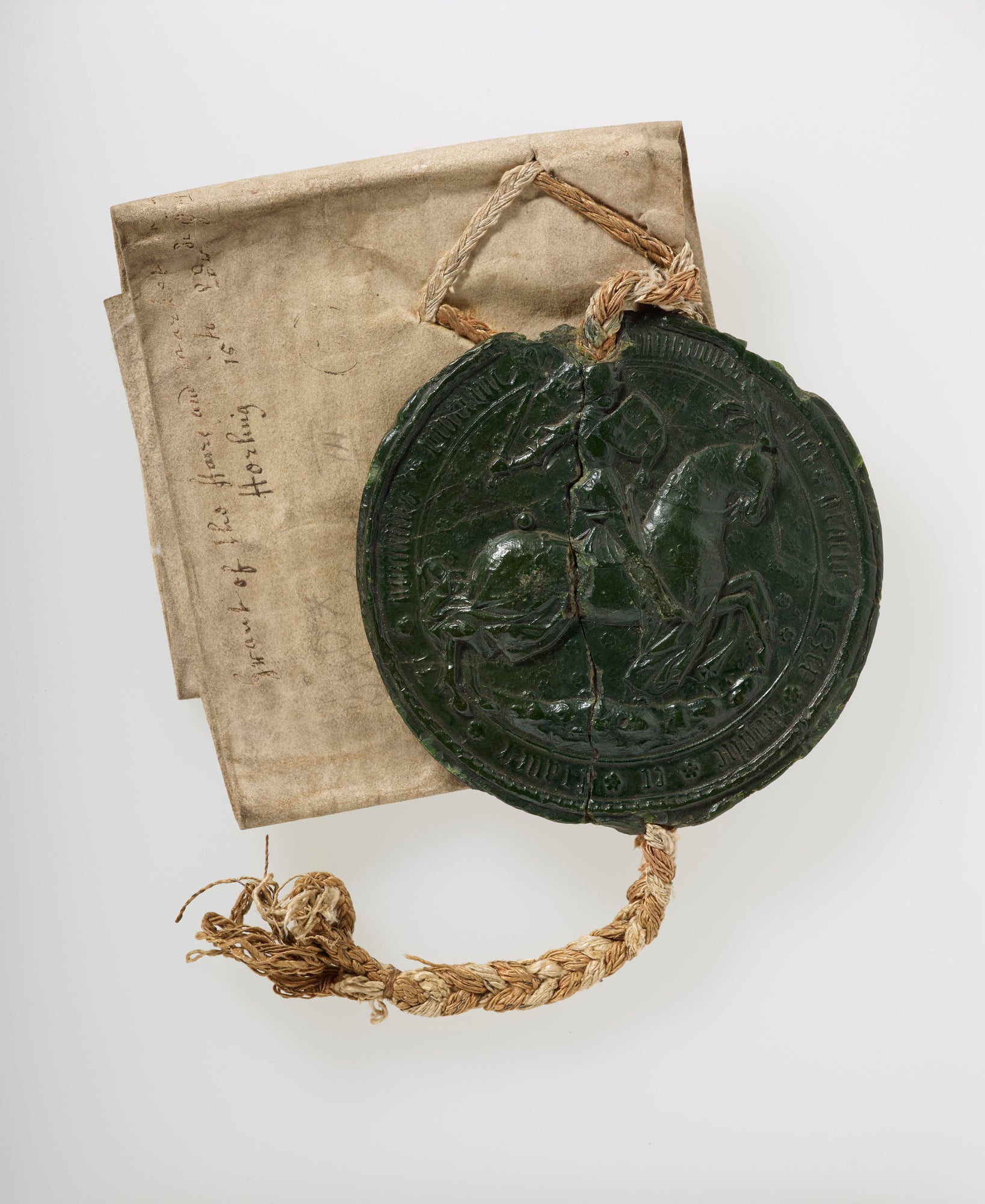 A vellum deed with black wax seal attached.Obverse of seal with enthroned Edward III, flanked by Royal coat of arms (England &amp; France quartered); reverse with Edward III in armour, on horseback. Trellis decoration of flowers behind. Seal on a plaited 