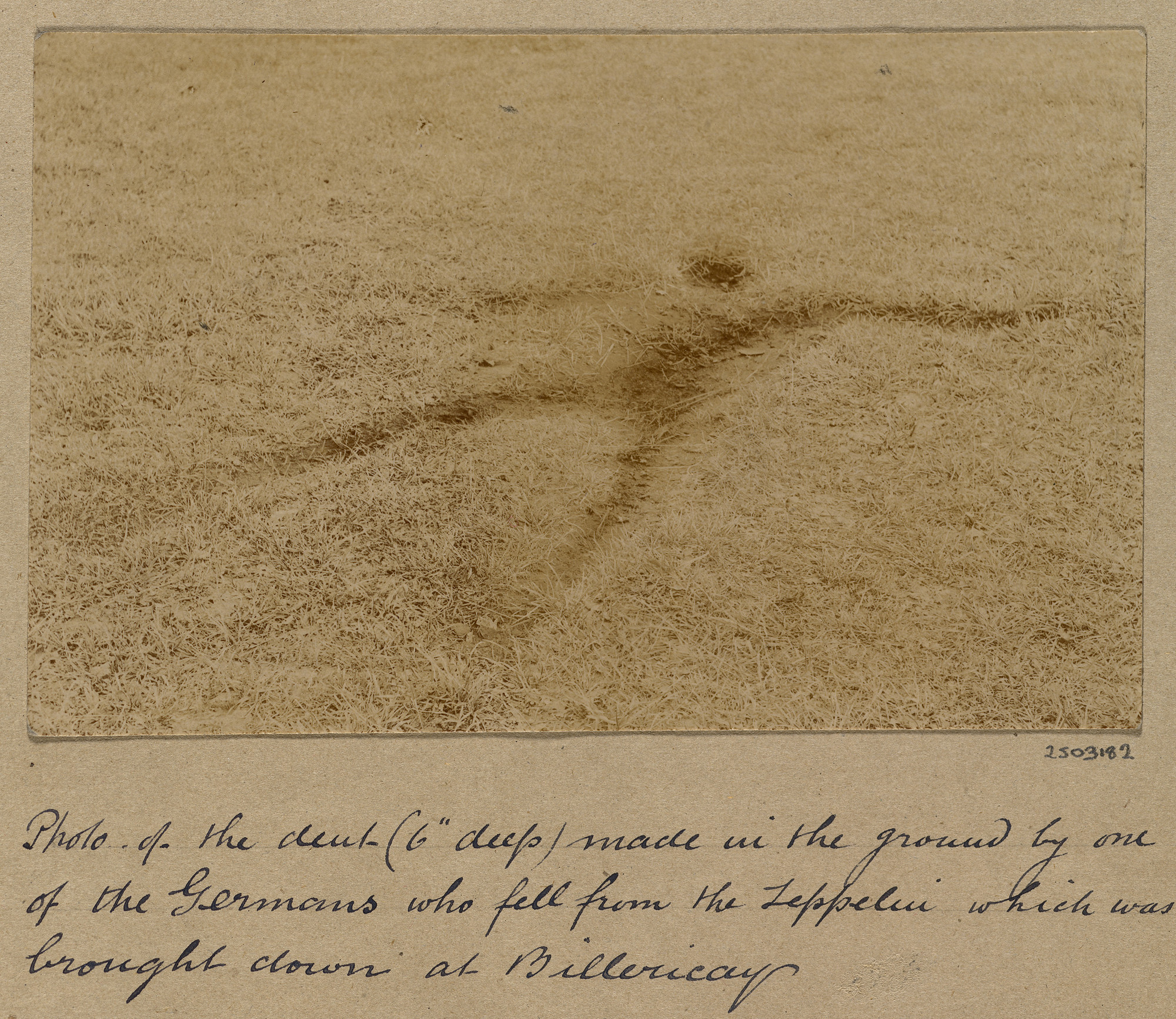 Impression left in the ground made by one of the German airmen of the L32 Zeppelin that was shot down near Billericay, Essex Photograph of a field featuring a hollow resembling a spreadeagled man. The hollow, or dent, was made by one of the German airmen who fell from the Schütte-Lanz L32 Zeppelin that was shot down at Great Bur