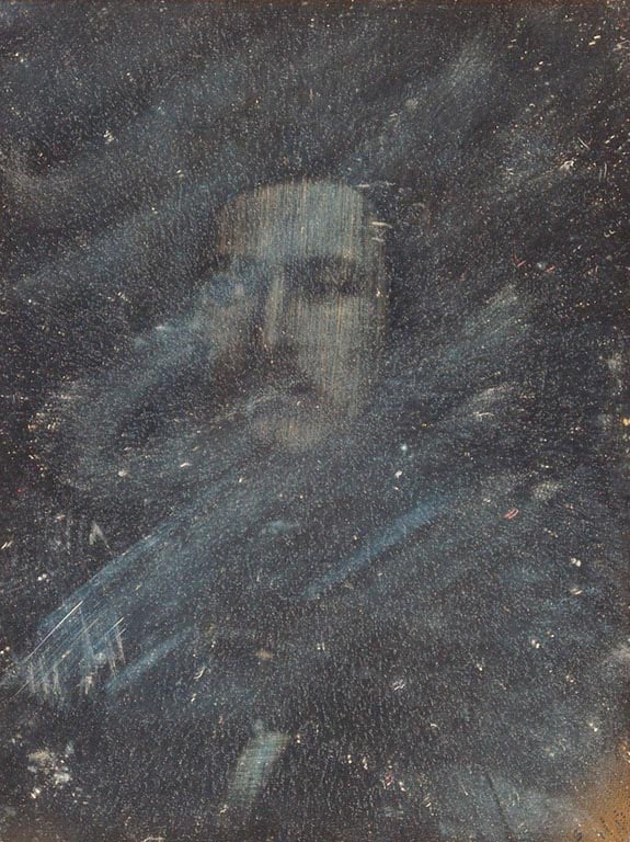 Daguerreotype, showing&nbsp;a head-and-shoulders portrait of Prince Albert looking slightly to the left. The image has now faded considerably. The daguerreotype is mounted in a dark brown leather case with a red velvet interior. 'P. A. Feb 1842' is emboss