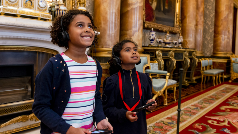 Children with multimedia guides in Buckingham Palace