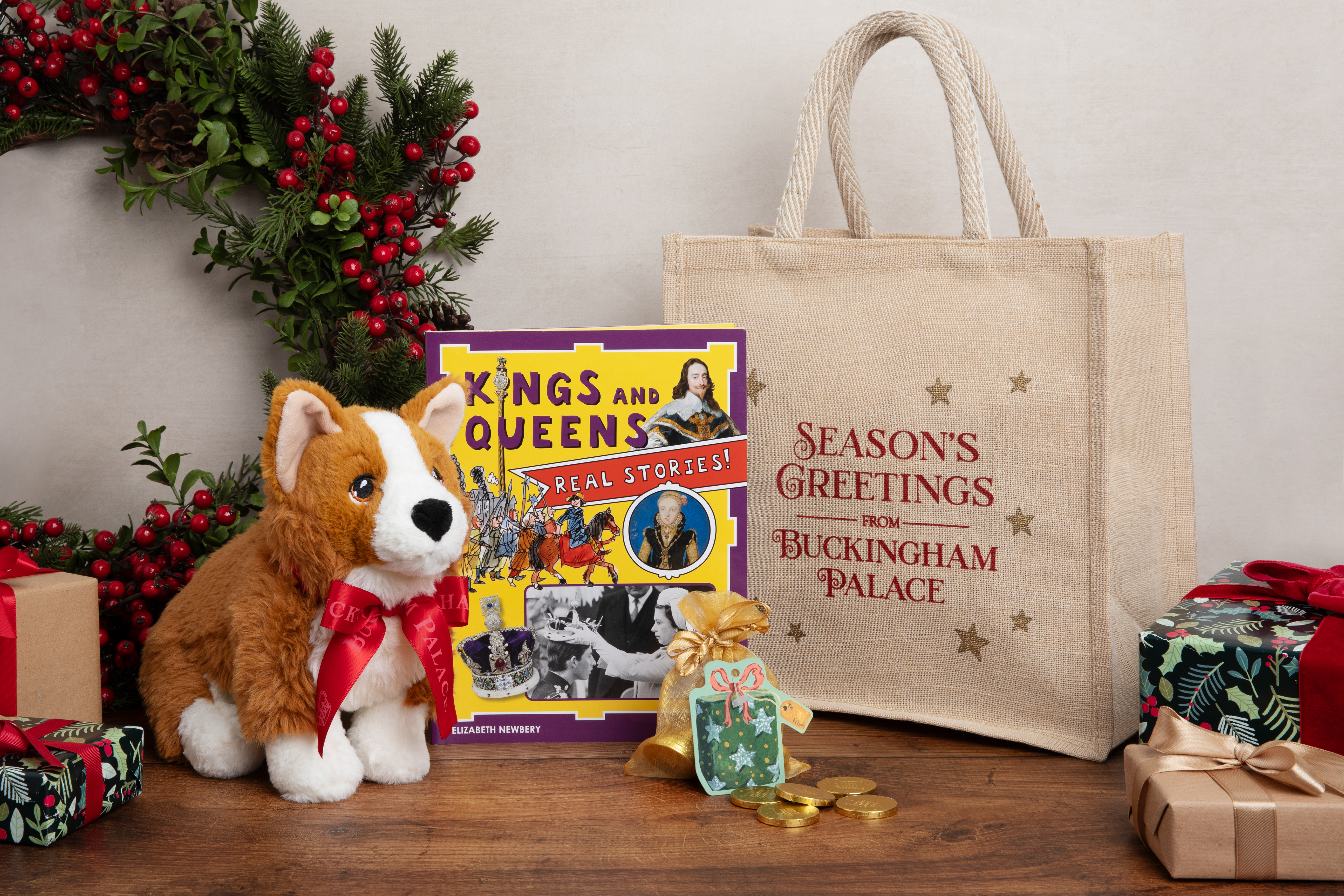 The items of the Childrens Christmas Eve Gift Bag present, including a cuddly toy corgi and a reading book