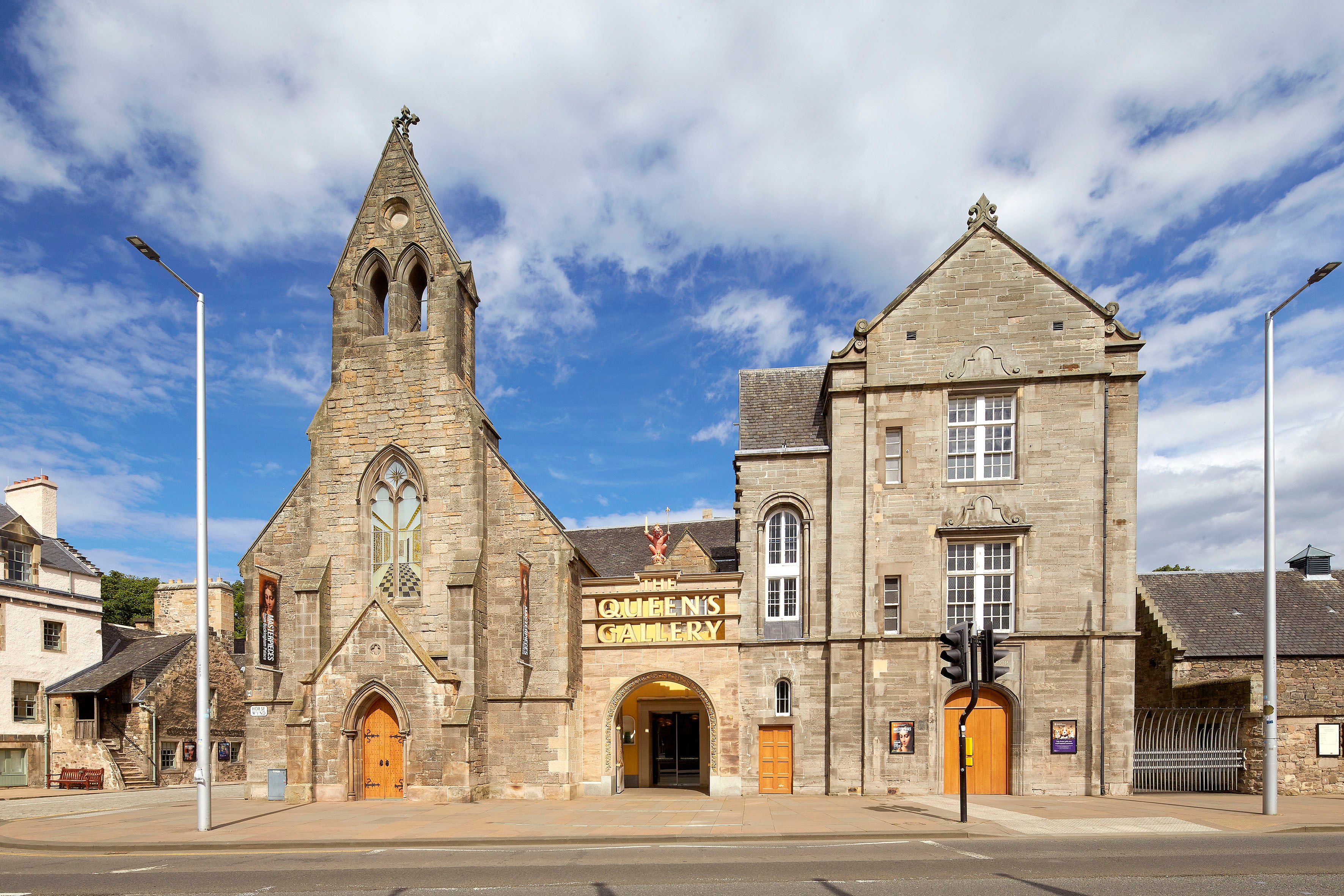 An image of the front of The Queen's Gallery, Palace of Holyroodhouse, showing the signage above the front doors. 