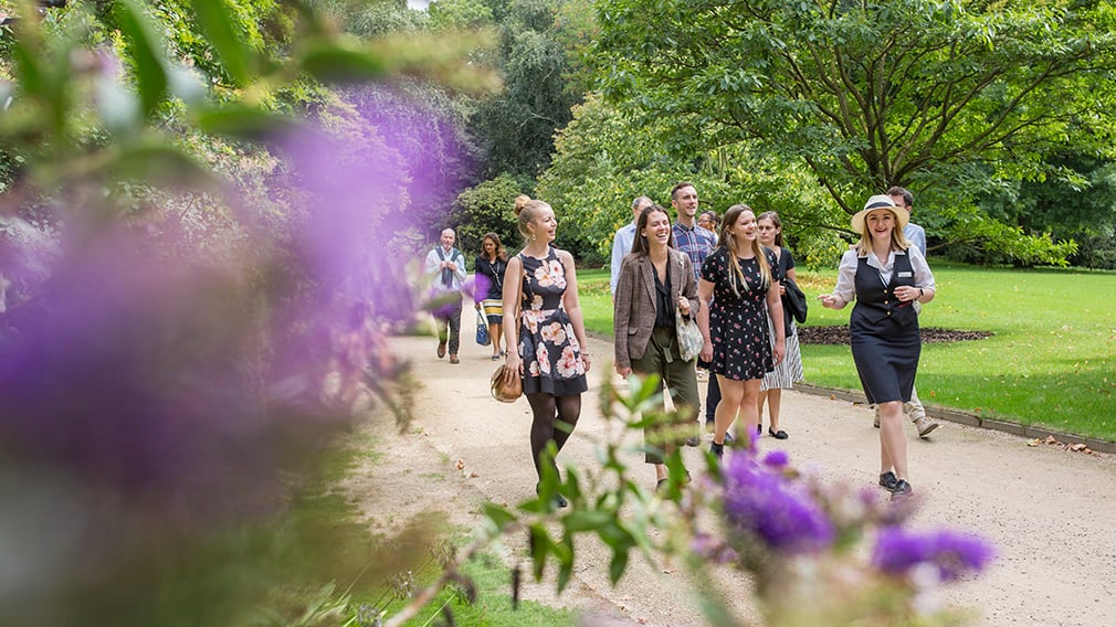 Garden Highlights Tour. Group of people being walking through the Buckingham Palace garden