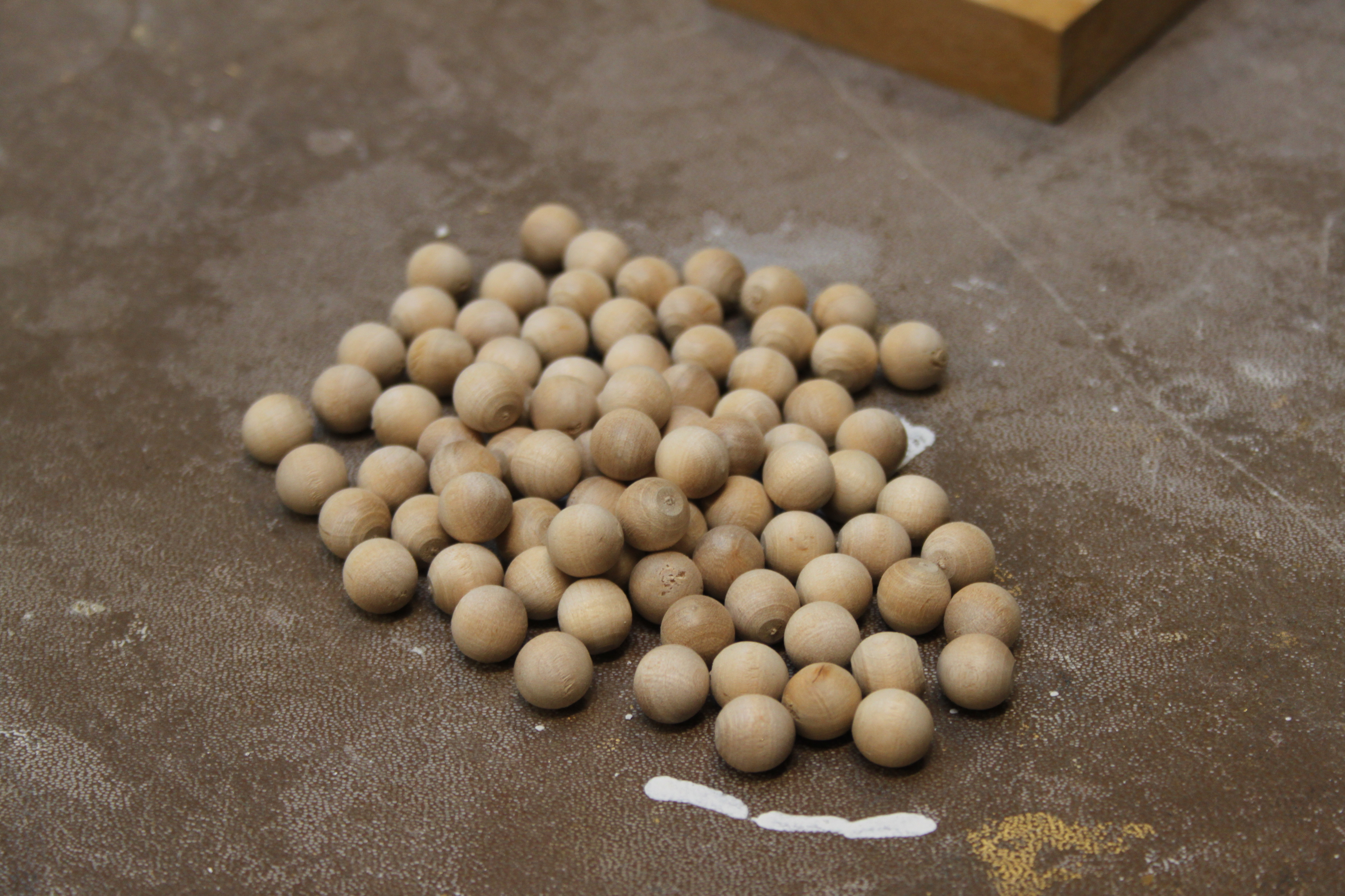 A pile of wooden balls awaiting the treatment
