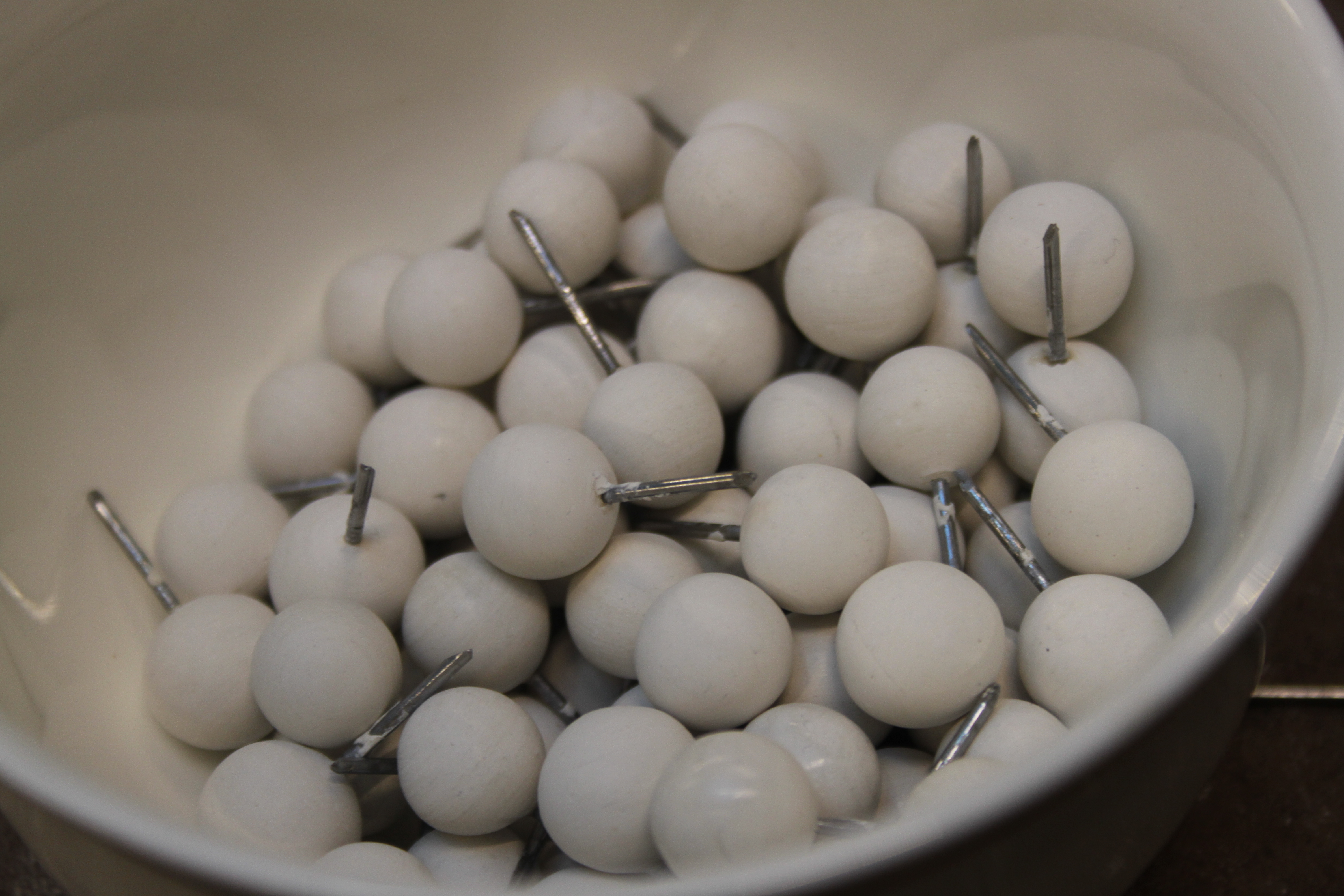 A pile of wooden balls having been coated in gesso