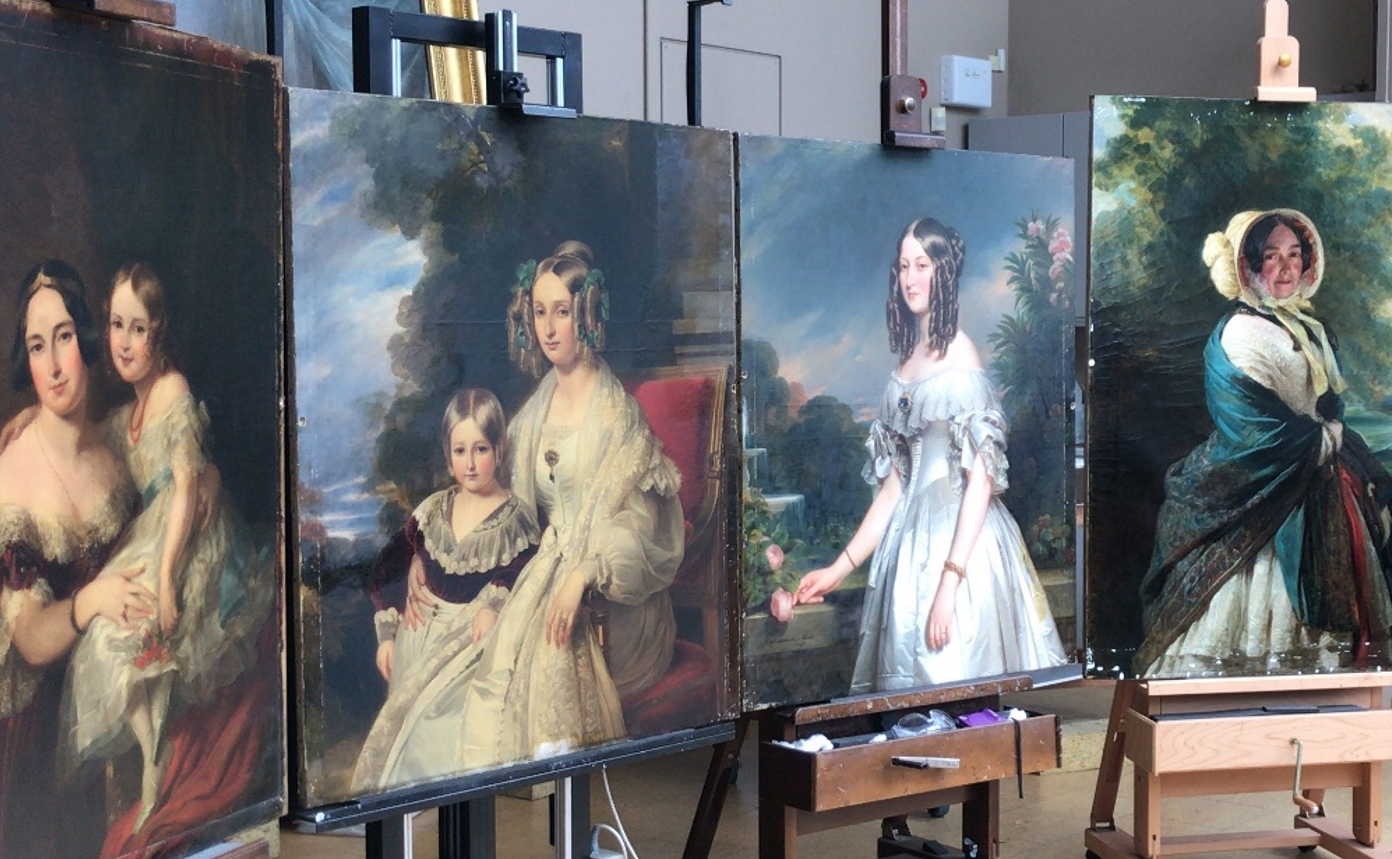 Four paintings together in the conservation studio Four paintings in a conservation studio