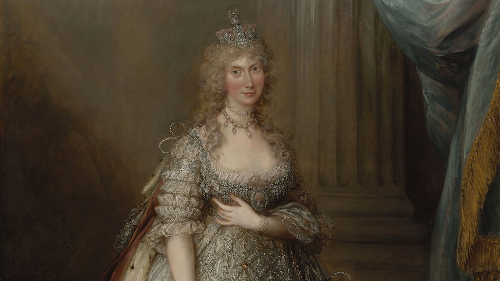 A painting of Queen Caroline wearing a silver wedding dress. She wears a crown and necklace