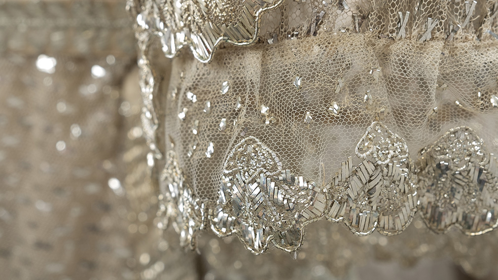 Sleeves of the dress. They have shell shaped edges embroidered in silver.