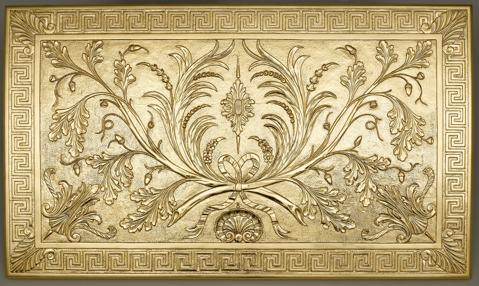 The burnishing is visible on this cut gesso table top. Compare the highly reflective surface of the laurel leaf motif with the matte background.