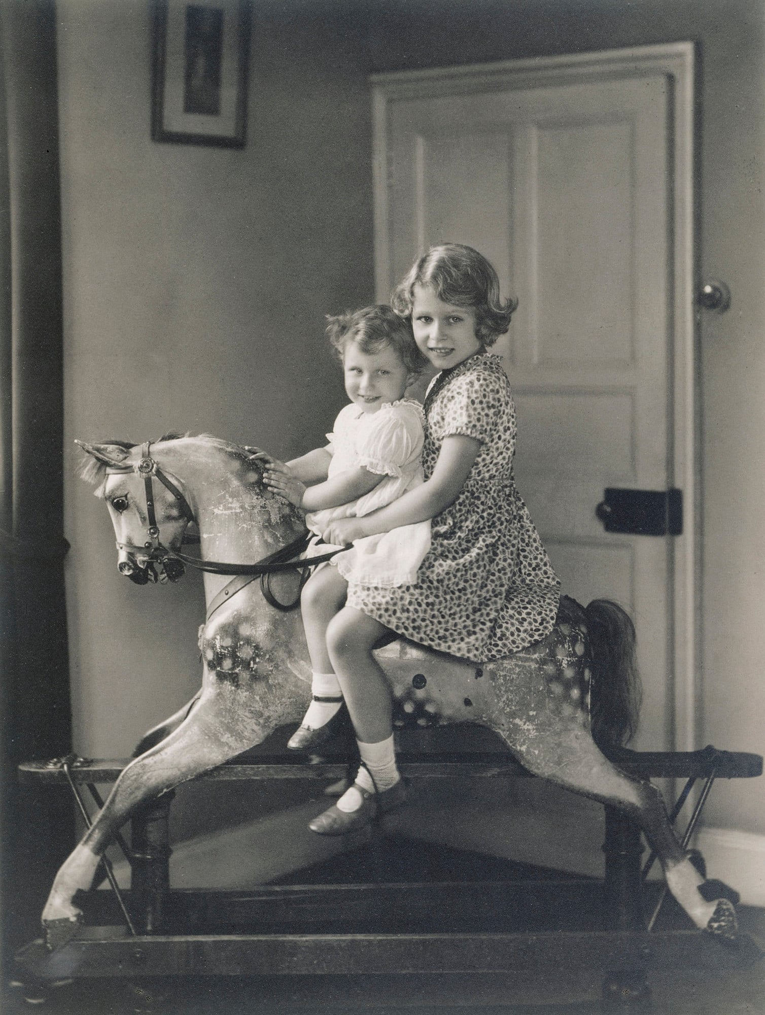 Princesses Elizabeth with her sister, Princess Margaret, riding a rocking horse in 1932. Princess Elizabeth and Margaret on a rocking horse