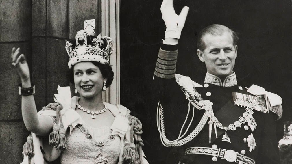 Queen Elizabeth II and Prince Philip, Duke of Edinburgh waving to the crowds from the balcony of Buckingham Palace (RCIN 2002628) Queen Elizabeth II and Prince Philip, Duke of Edinburgh waving to the crowds from the balcony of Buckingham Palace. She is wearing the a crown and coronation robes