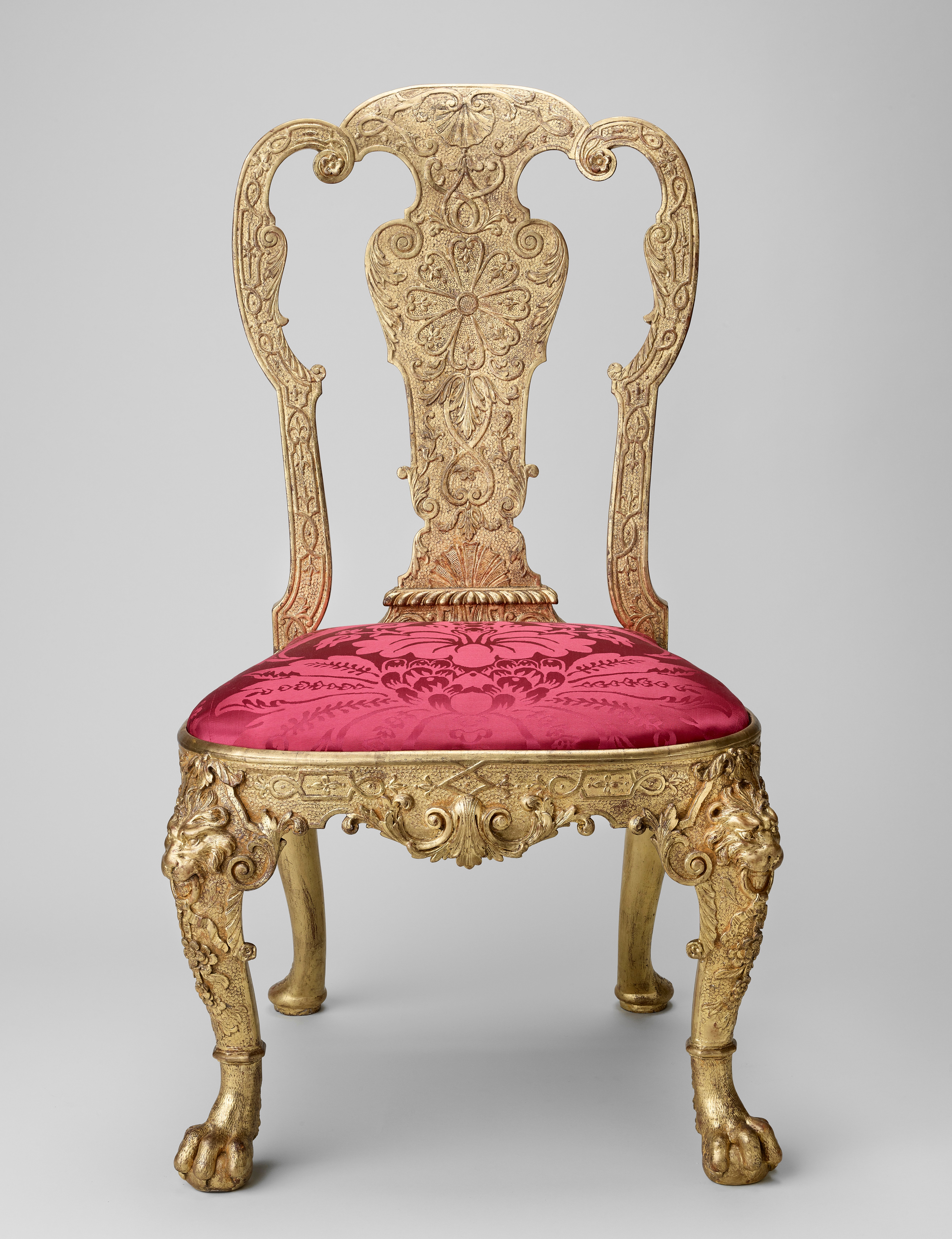 The gilded ornament on this chair back has been carved into a thick surface of gesso. This would have been brushed onto the flat wooden surface below, and built up in many layers.