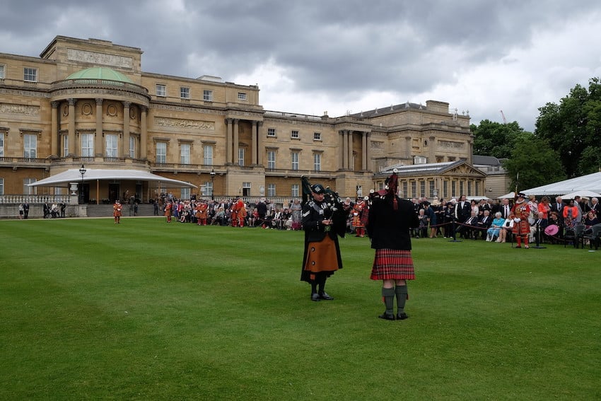 Garden party at Buckingham Palace with two pipers