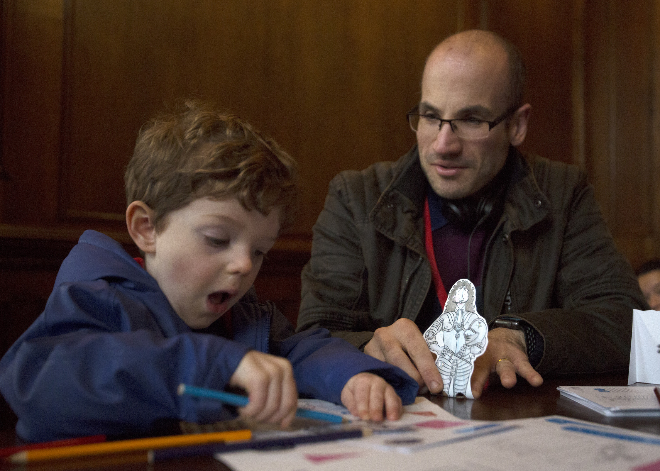 Child making a paper puppet