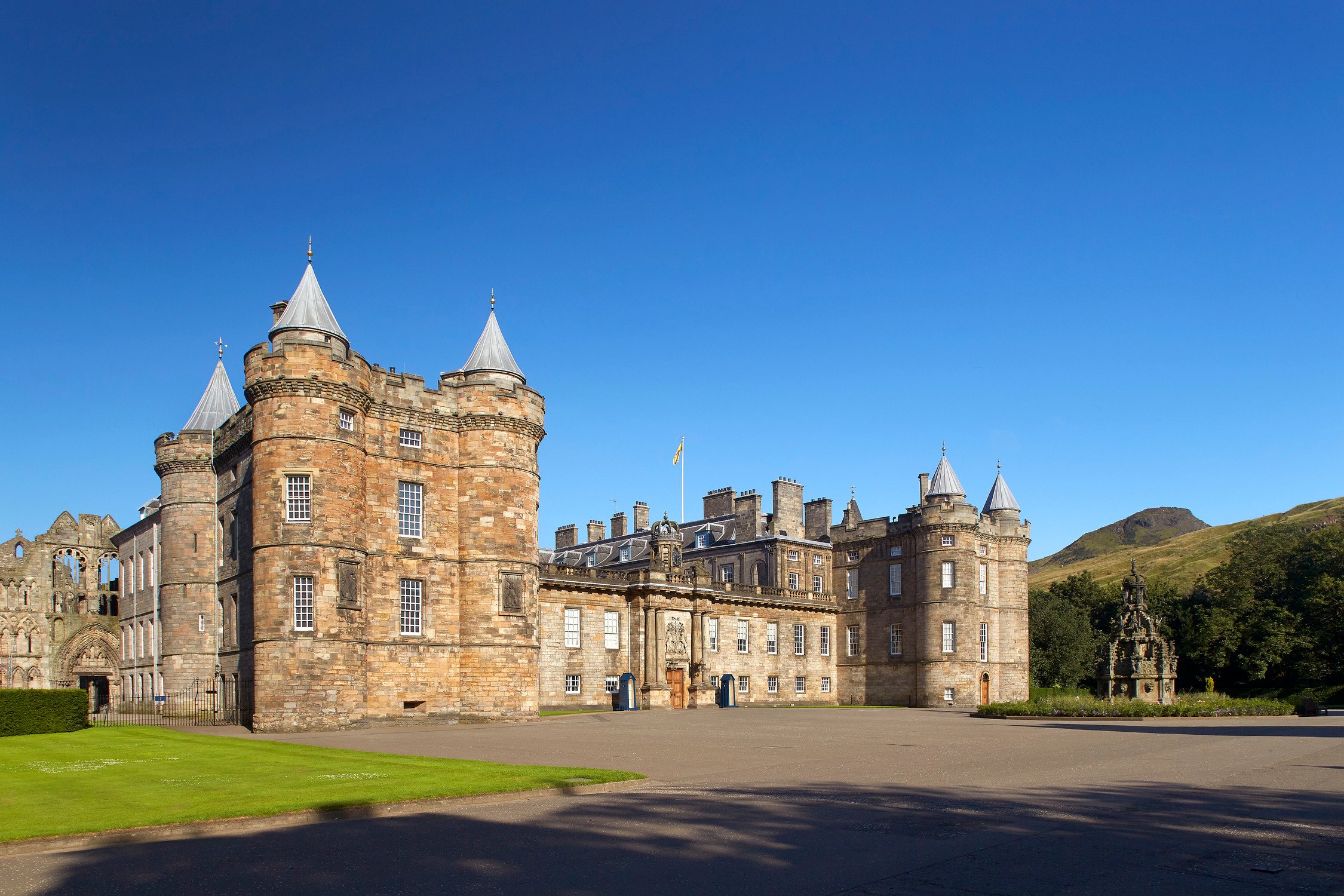 Image of Palace of Holyroodhouse with Holyrood Park  and Arthurs seet in background 