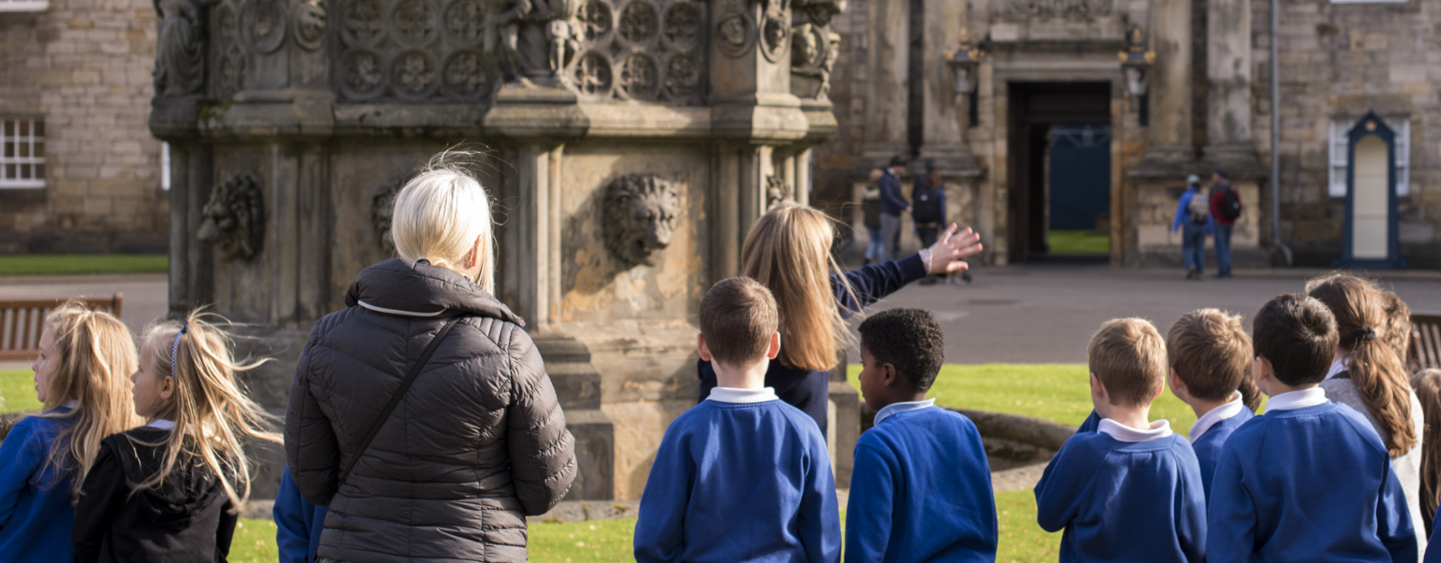 Group of school children looking towards the Palace of Holyroodhouse
