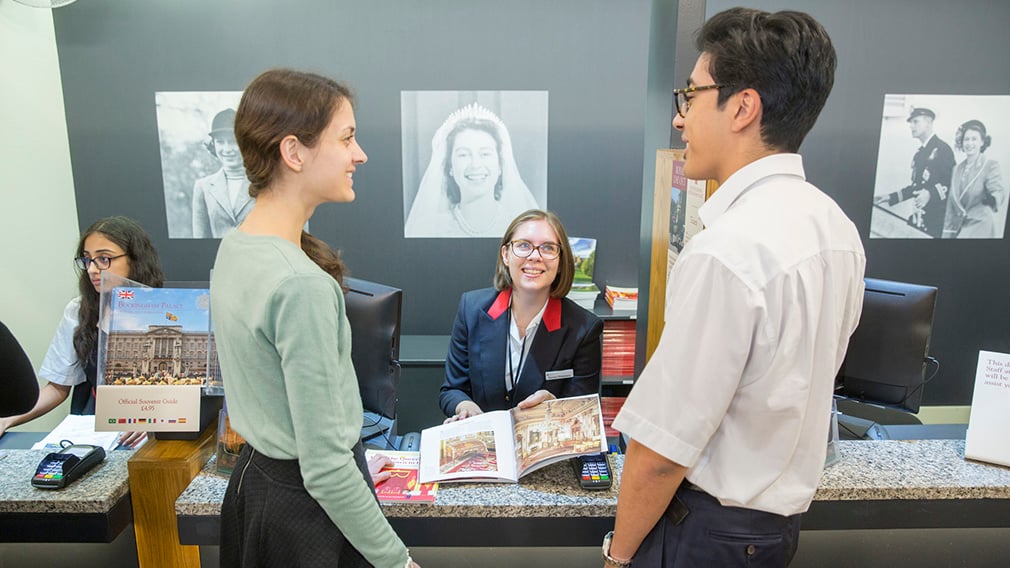 Ticket sales assitant talk to two customers