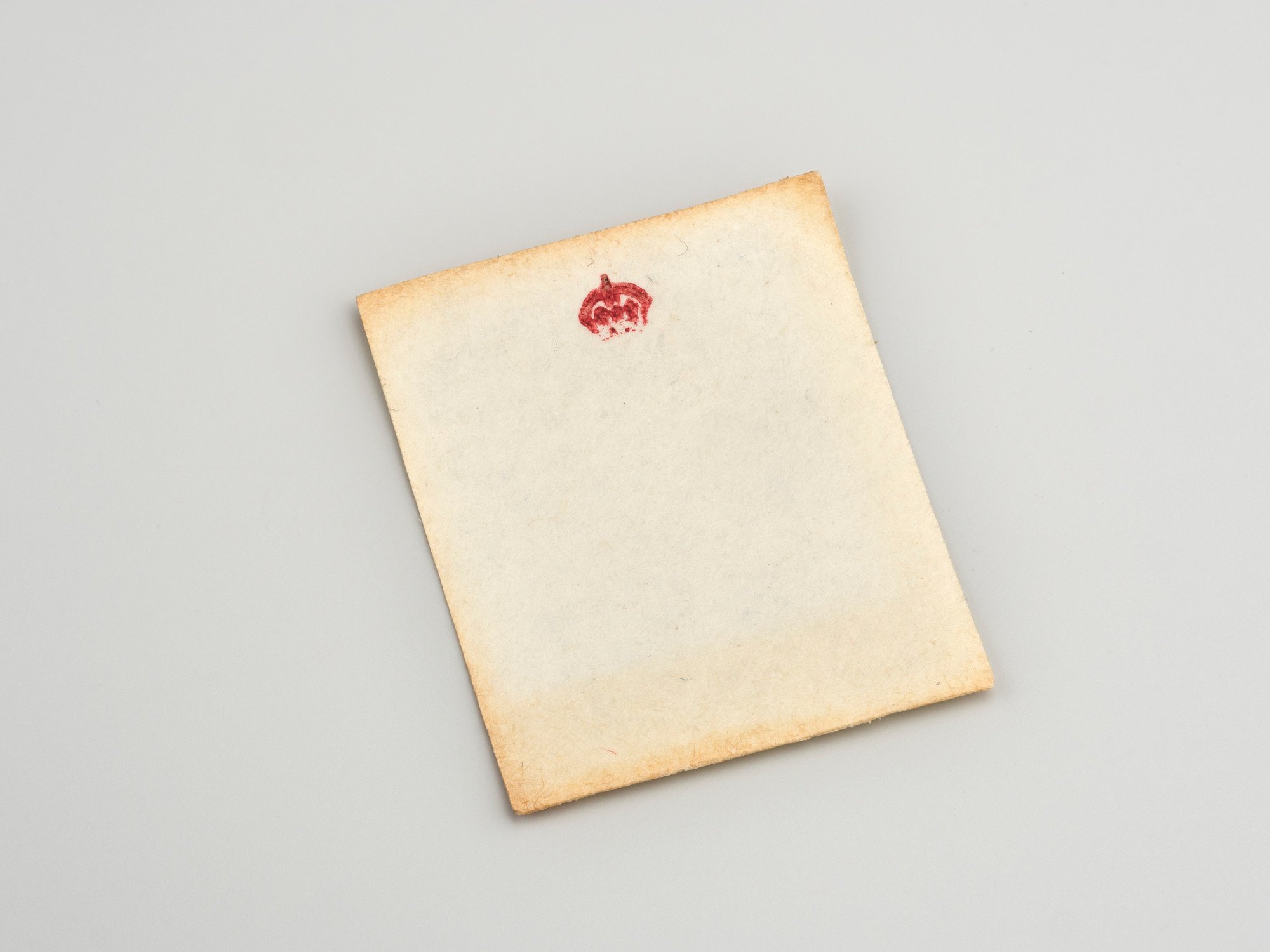 Miniature writing paper with crowned M monogram in red.