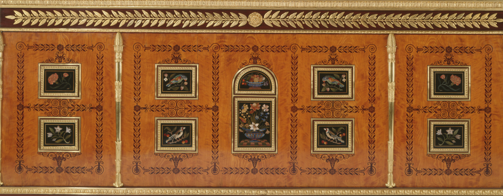 close up of wooden cabinet decorated with inlaid flowers and birds
