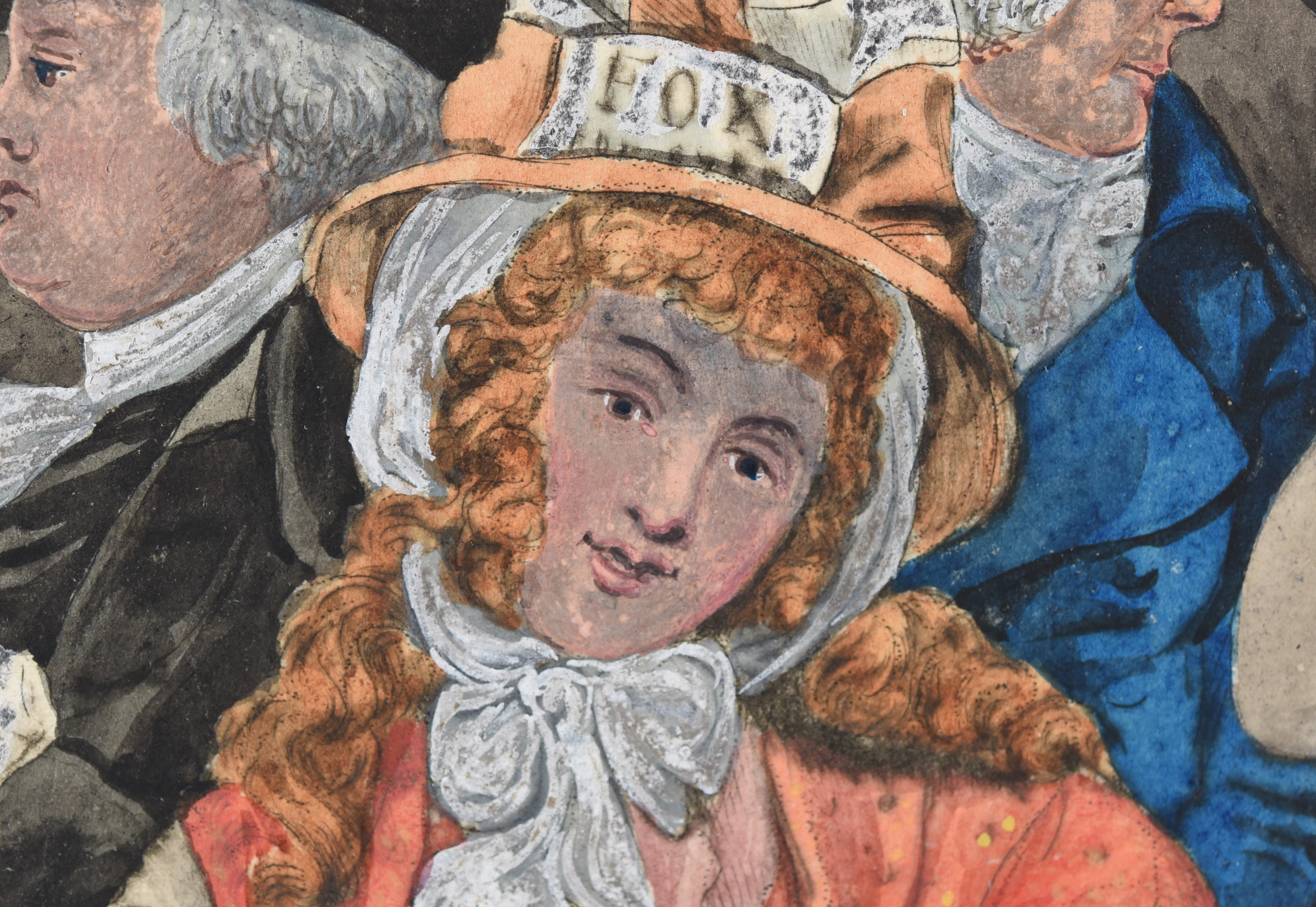 A woman's face. She wears a peach hat and peach coloured shawl.