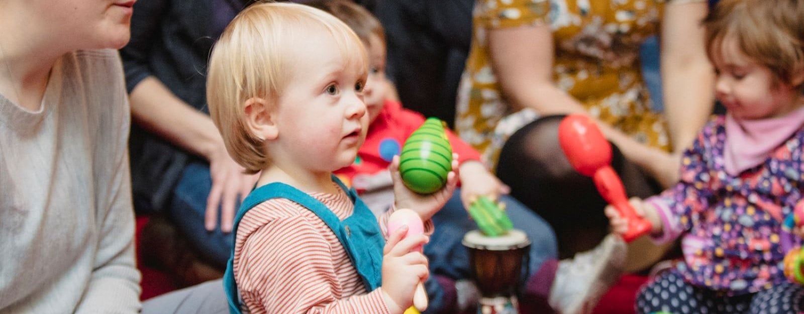 Young children holding maracas