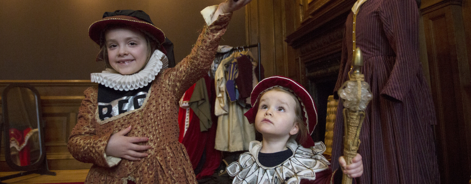 Two children dressing up in historical costumes