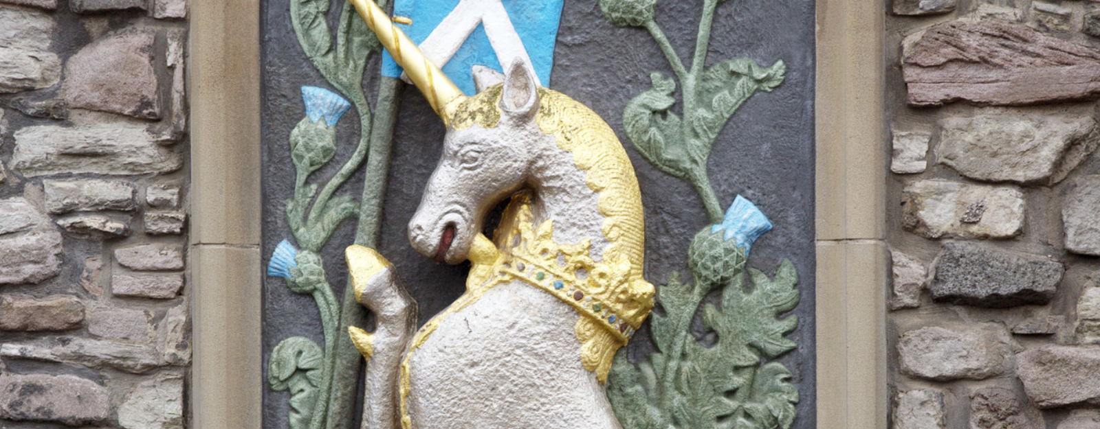 painted stone carving of a unicorn 