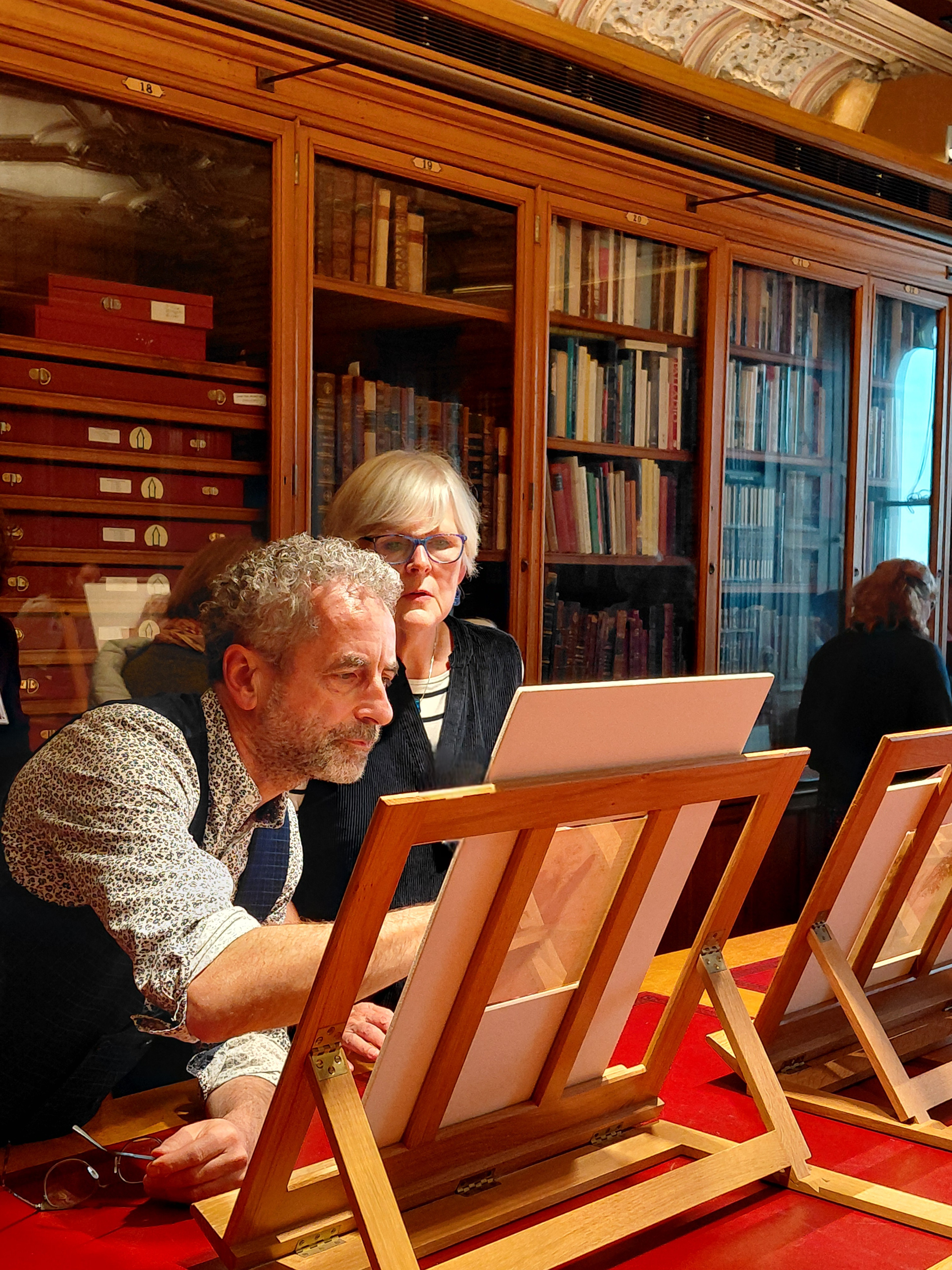 Close up of Martin Clayton showing Leonardo drawings to an RSN student in The Print Room, Windsor Castle