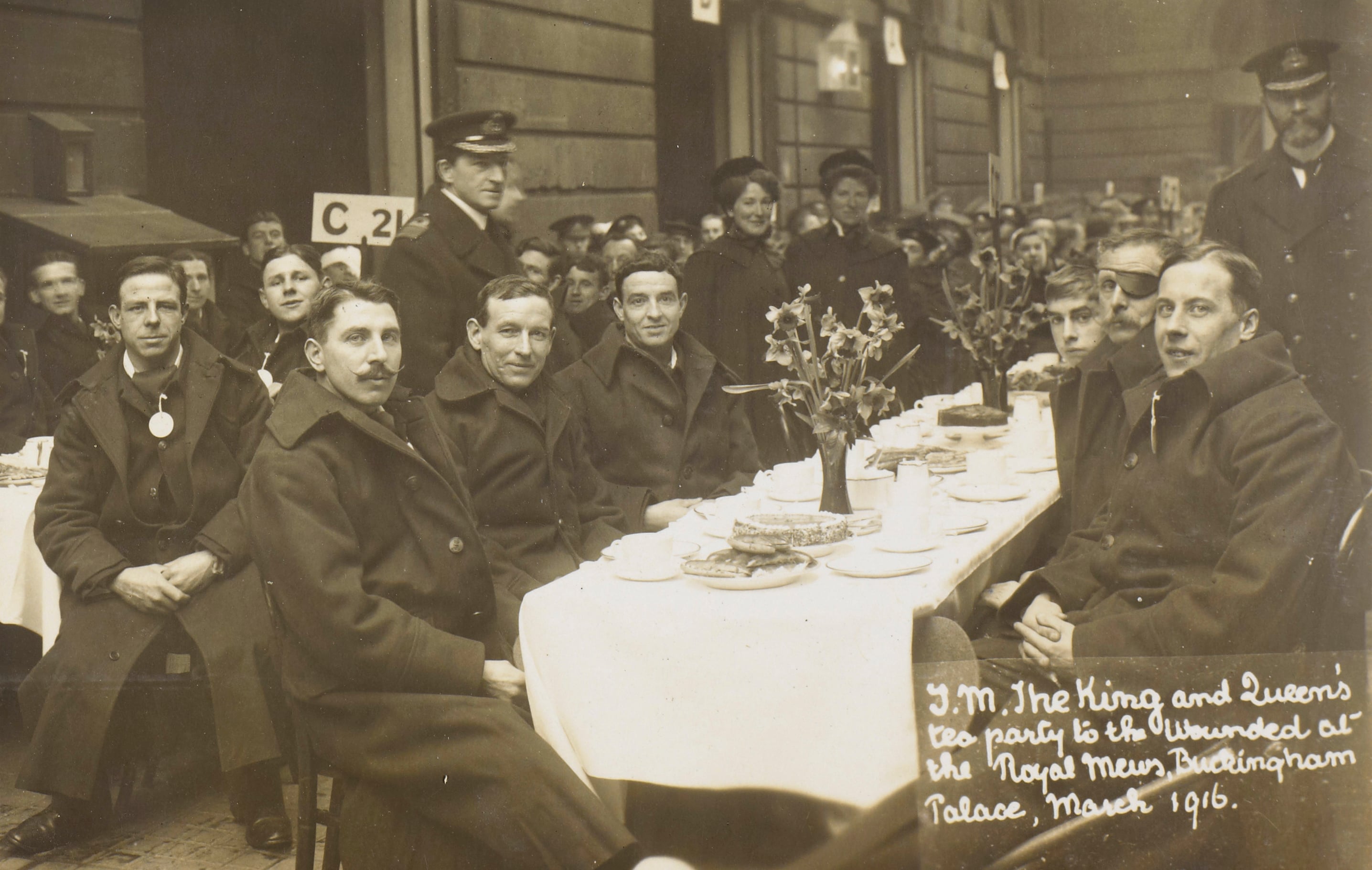 photographs from Queen Mary’s photograph album showing the tea party held for wounded soldiers in the Royal Mews during the First World War, with captions written in Queen Mary’s own hand.