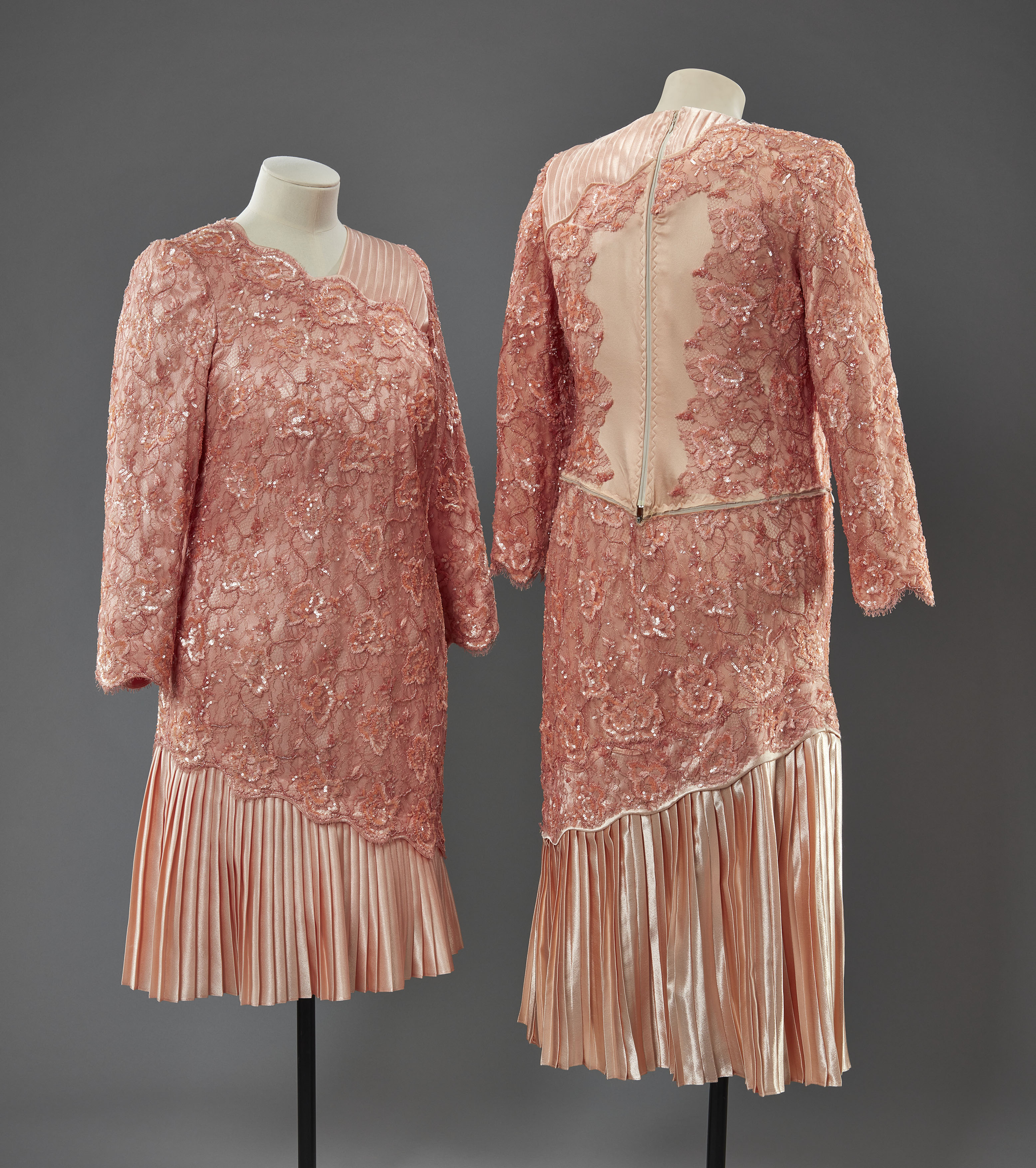 Pink dresses worn by Queen Elizabeth II (left) and her stunt double (right) for the London 2012 Olympics Opening Ceremony Two salmon pink dresses on mannequins
