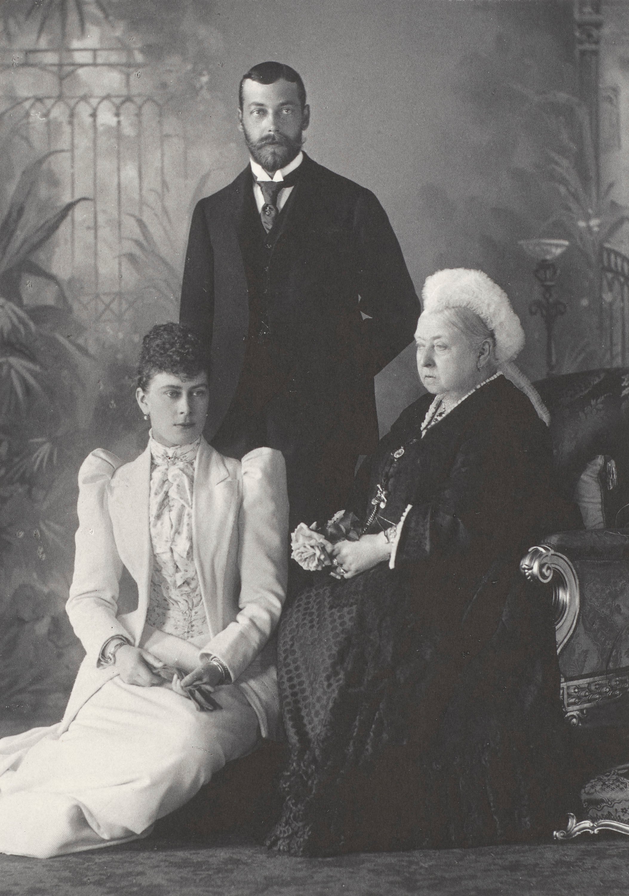 Black and white photograph of Queen Victoria with George V and Queen Mary, when Duke and Duchess of York