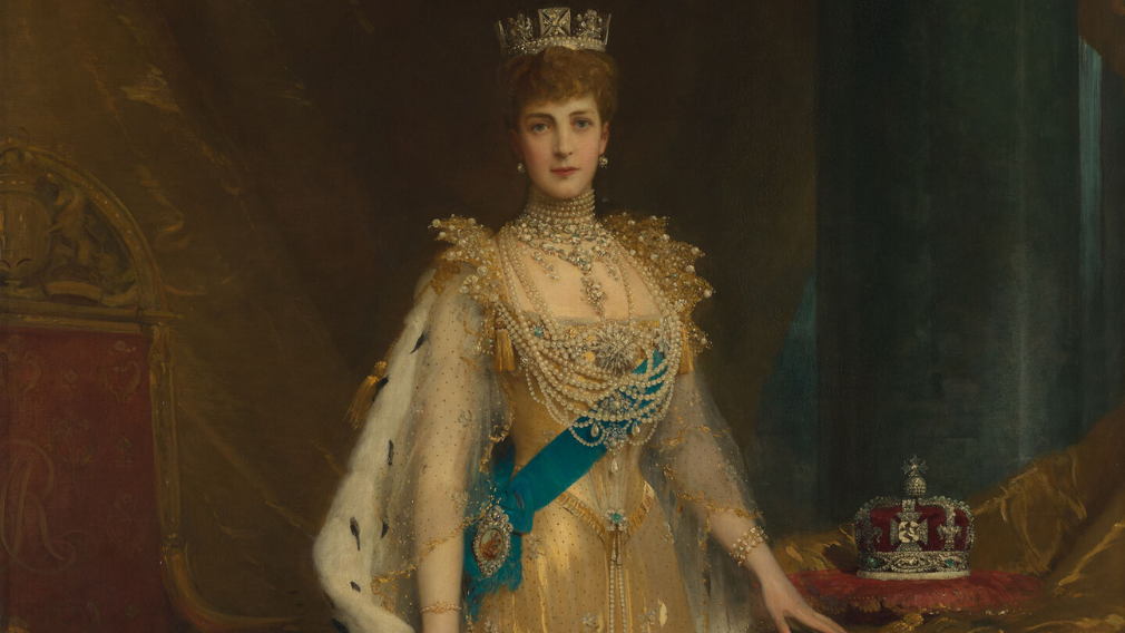 Sir Samuel Luke Fildes, Queen Alexandra (1844-1925), 1905 (RCIN 404554) This is the State portrait of Queen Alexandra. The Queen is depicted wearing Coronation robes over a gold dress with the George IV diadem with ropes of pearls and diamonds around her neck; her crown rests on a cushion to the right.