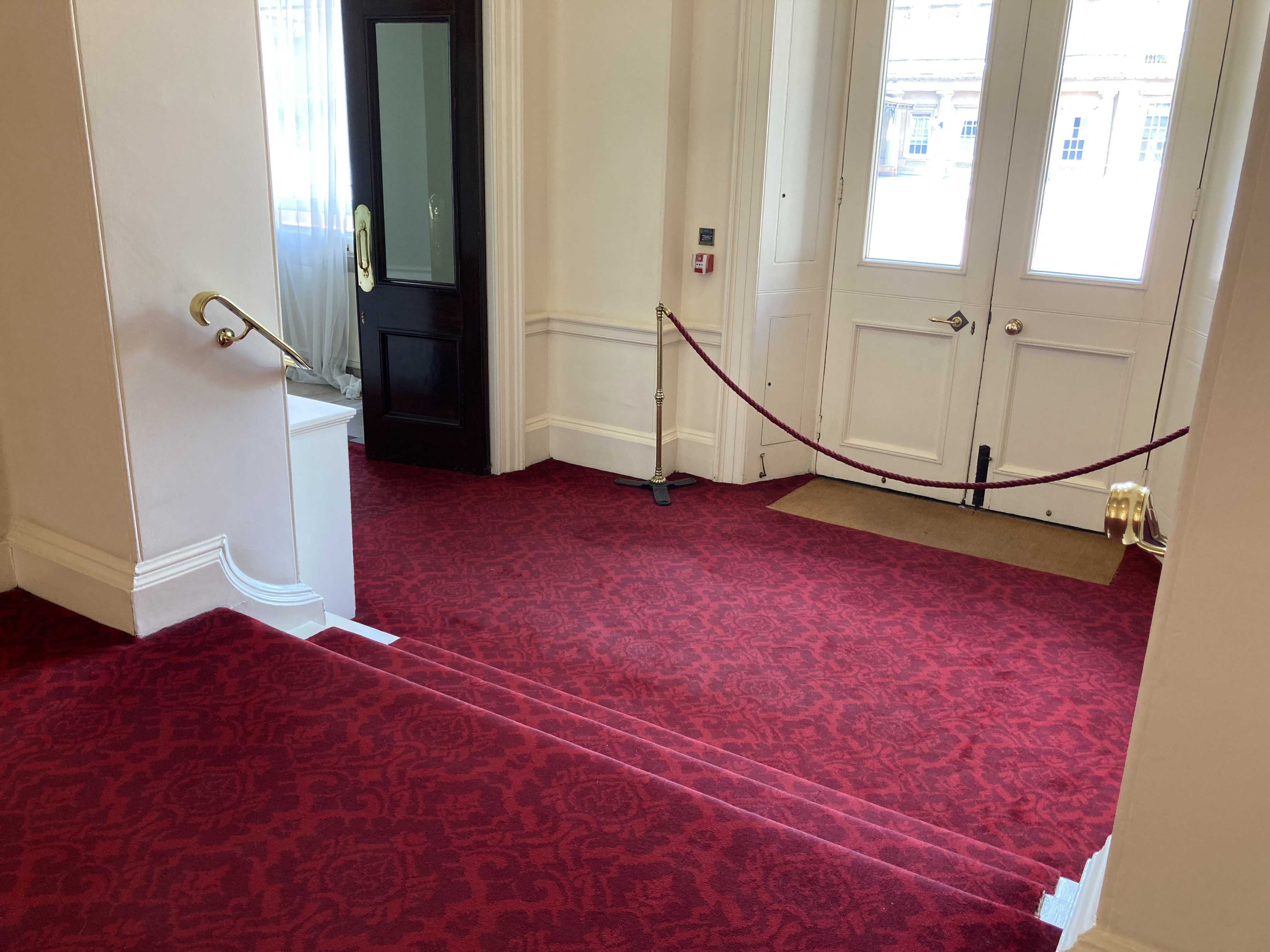 3 red, carpeted steps down