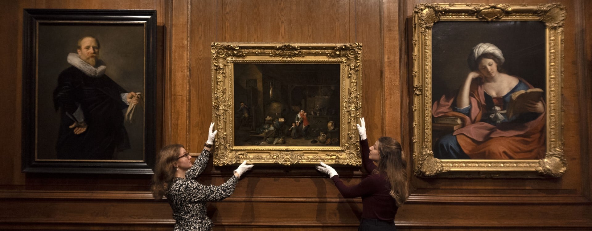 Curators put finishing touches to a display of paintings at the Palace of Holyroodhouse