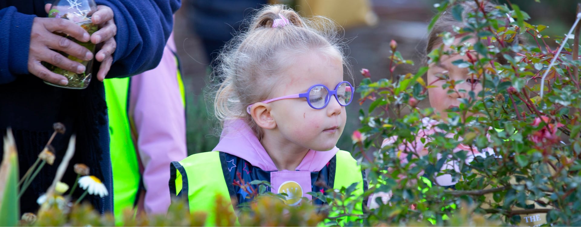 Explorer Royal Rhyme Time A child looks at flowers in a garden