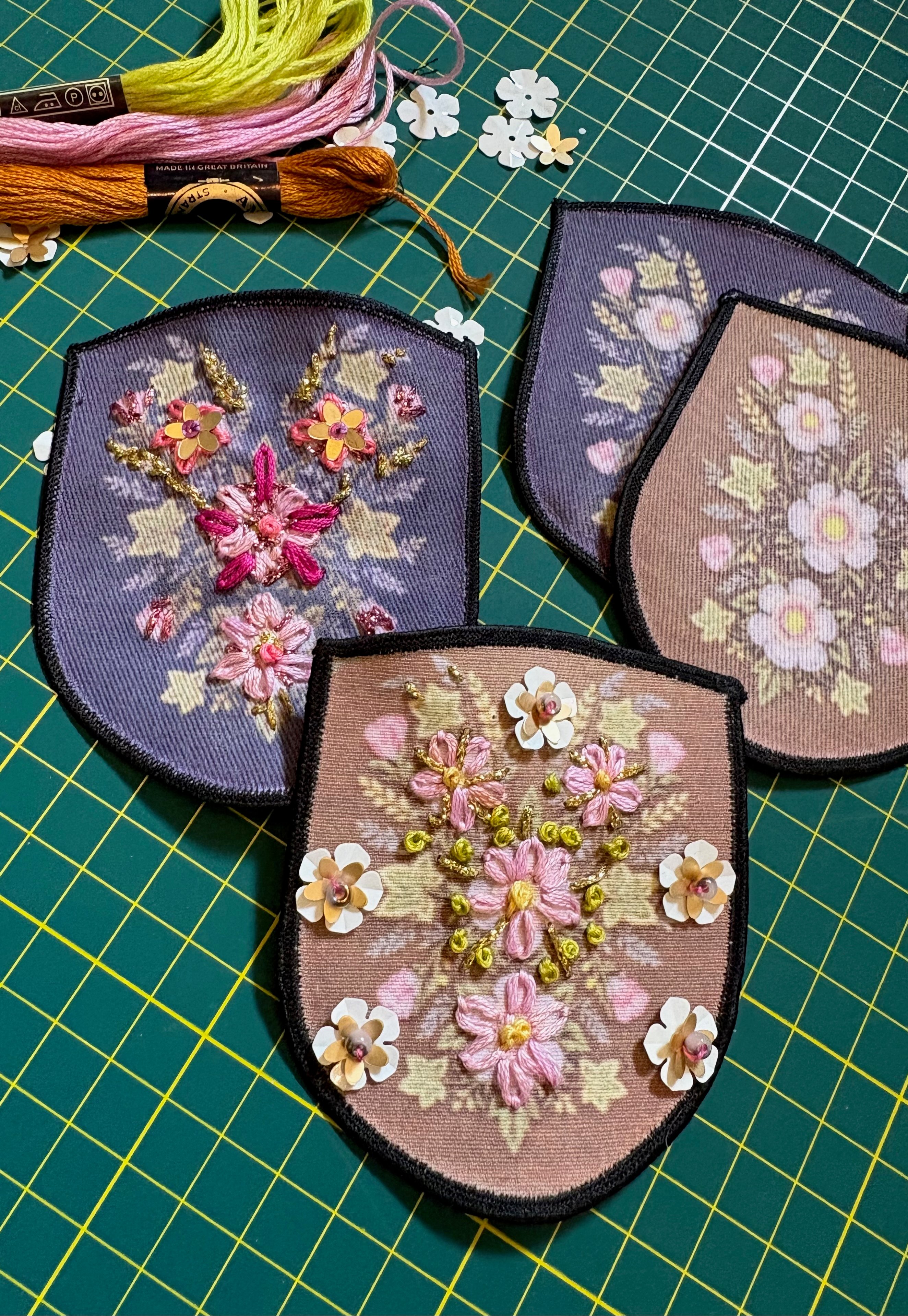 Image showing some of the completed patches, along with embroidery thread and loose sequins