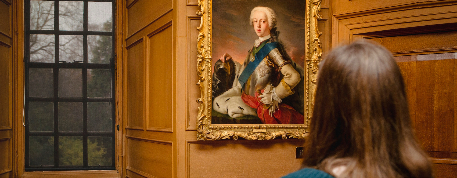 A visitor looking at a portrait of Bonnie Prince Charlie