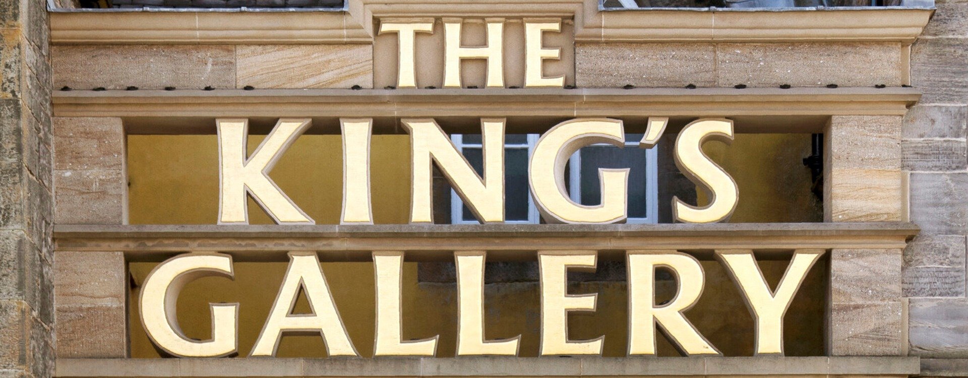 Image of the front of The King's Gallery. carved sandstone gilded with the words Kings Gallery