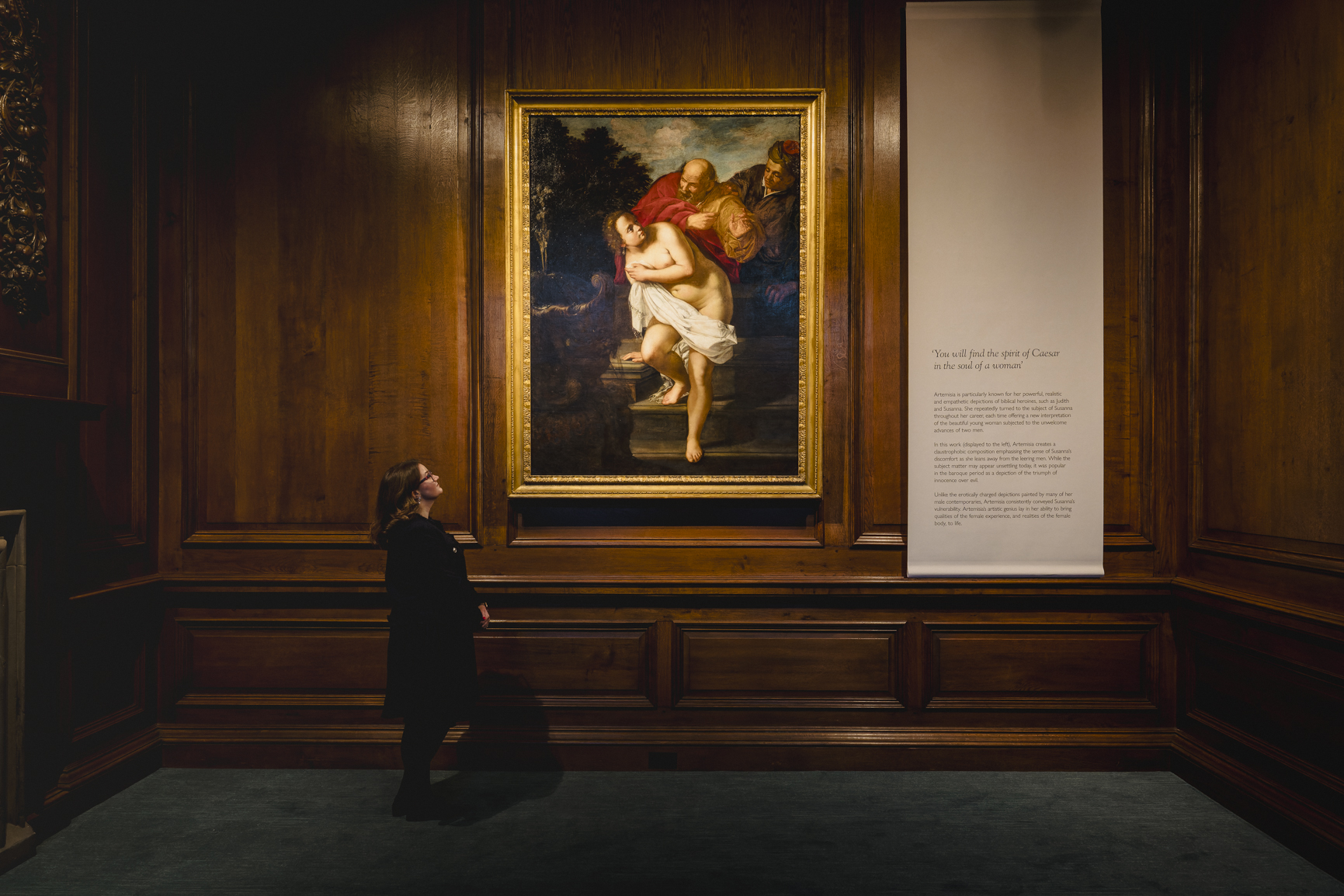 A Royal Collection Trust staff member looking at the rediscovered Artemisia painting which has recently gone on display in Scotland for the first time
