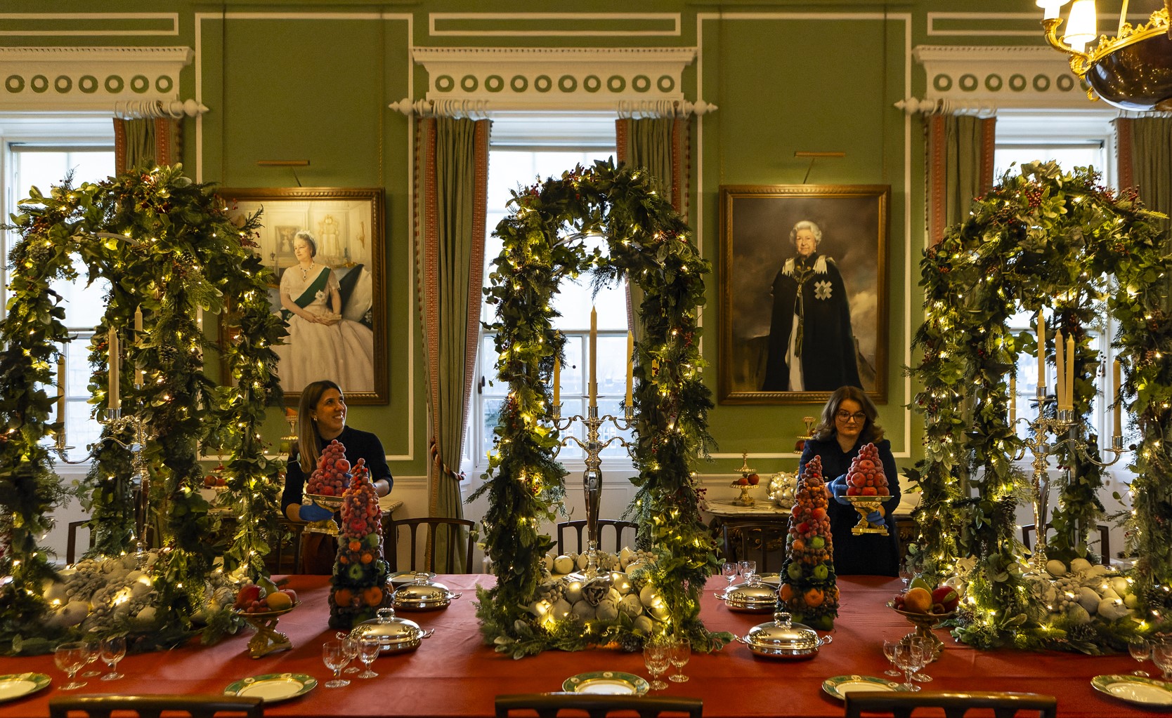 Staff making final adjustments to the Christmas table display in the Royal Dining Room