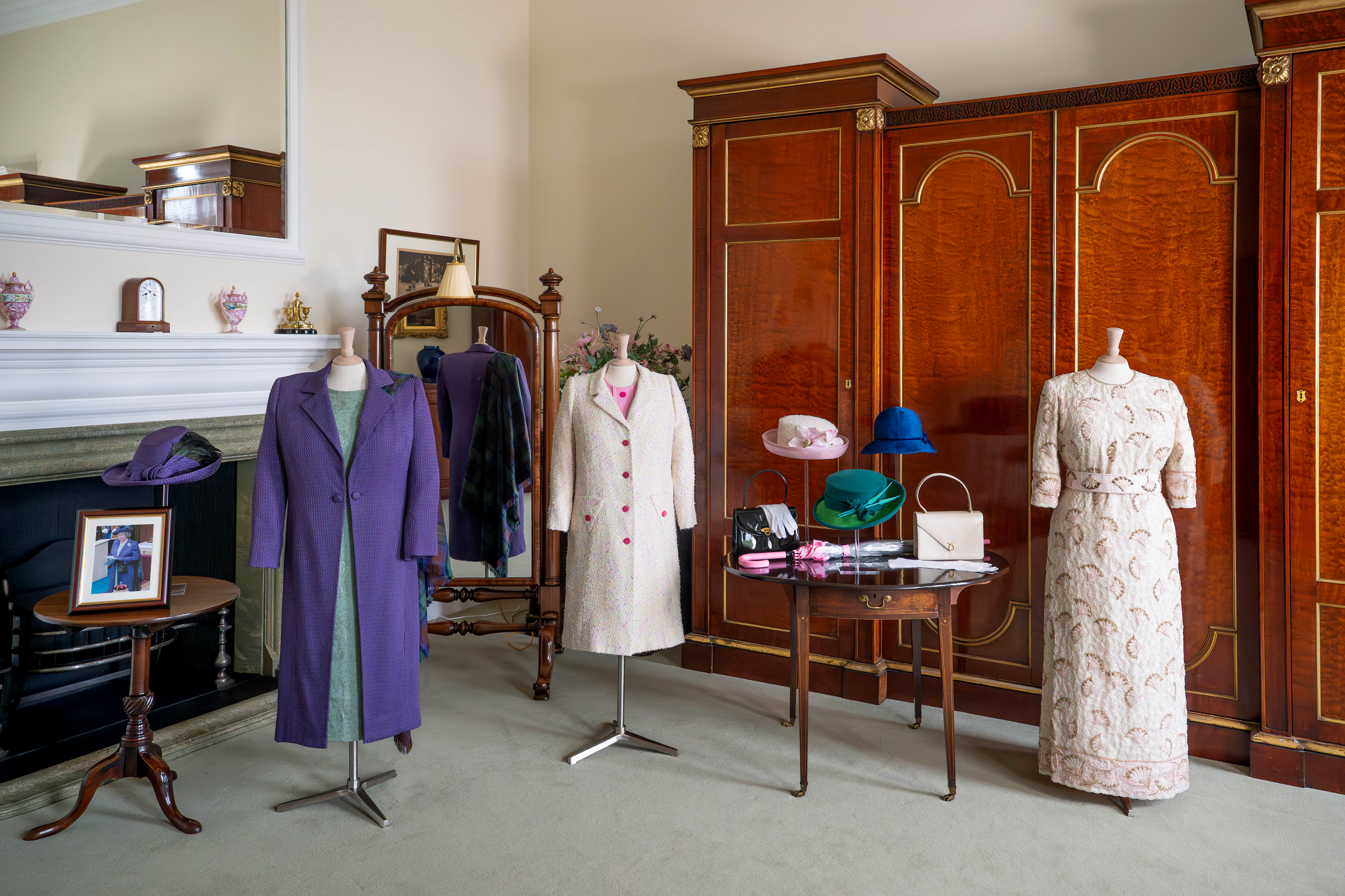 Three of the late Queen's outfits on display in the Queen's Dressing Room