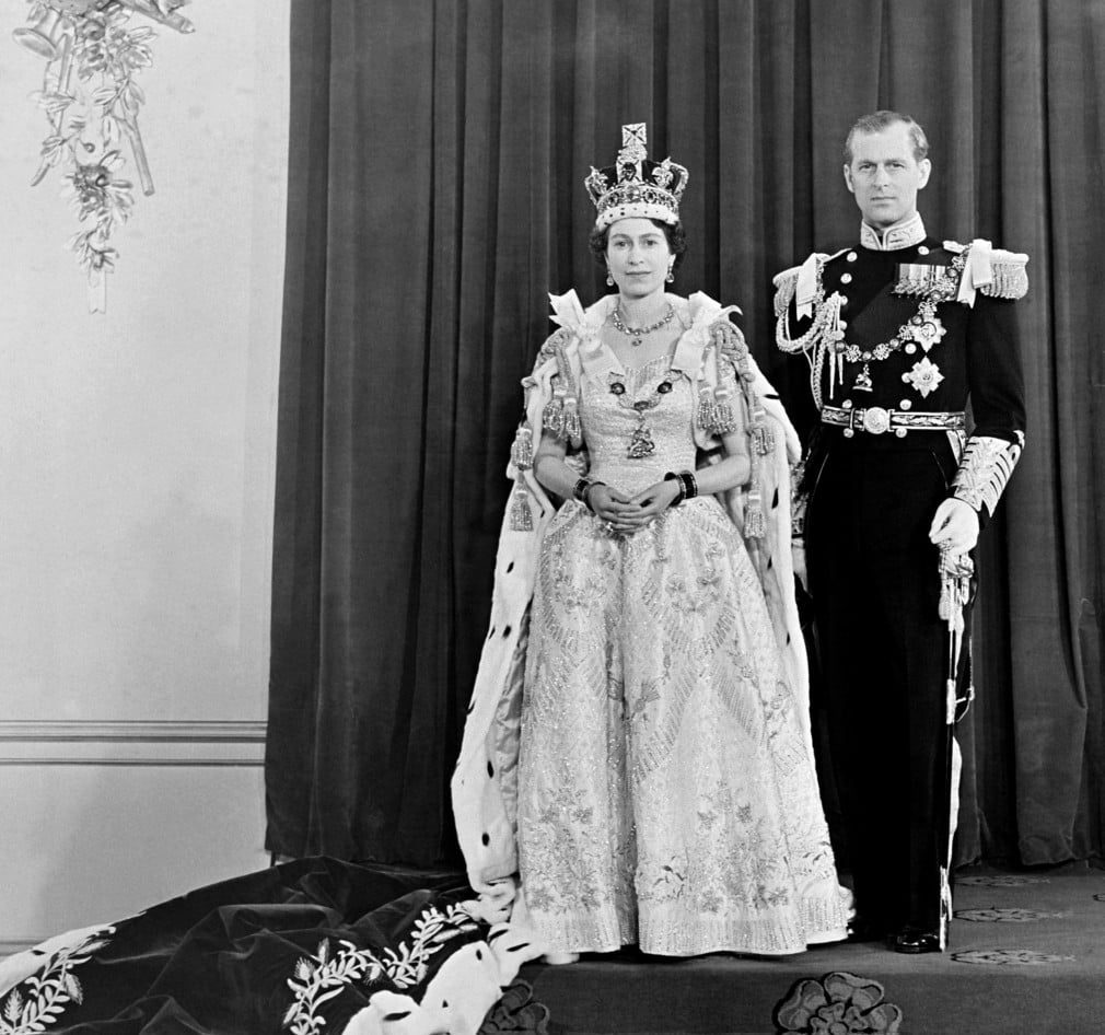 Queen Elizabeth II and the Duke of Edinburgh at Buckingham Palace after her Coronation in Westminster Abbey. Queen Elizabeth II and the Duke of Edinburgh stand next to each other for a portrait in their Coronation outfits.