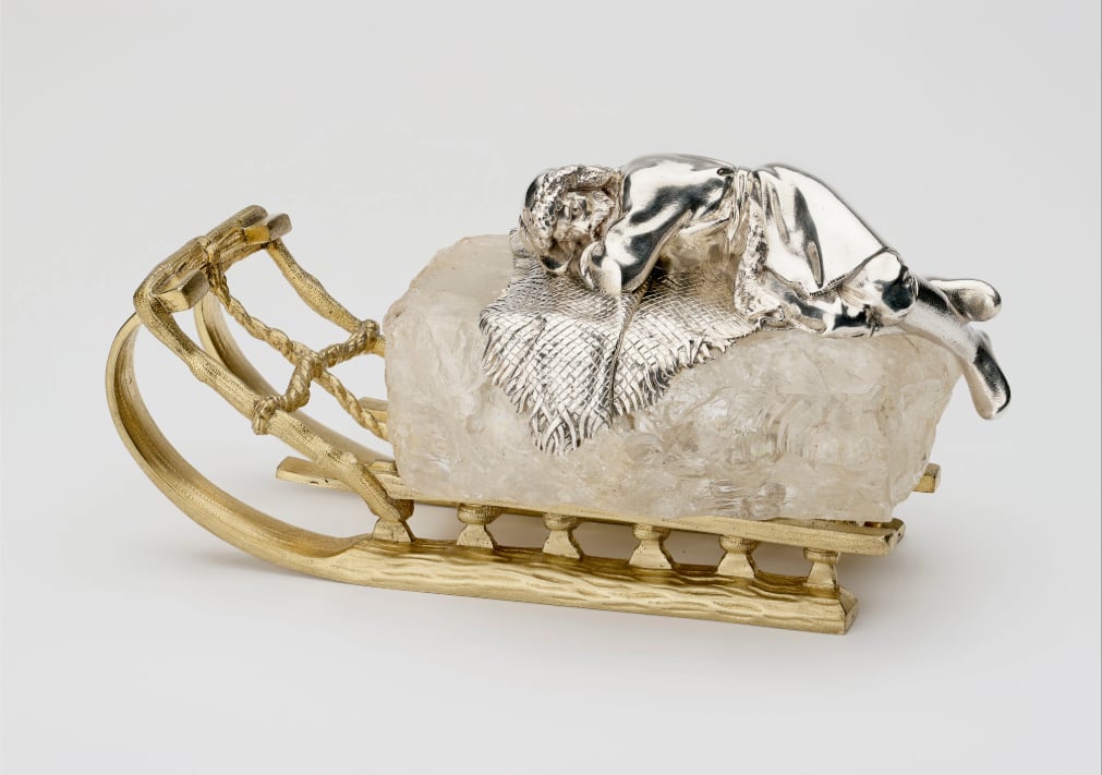 RCIN 46009 - Paperweight A paperweight in the shape of a figure sleeping on a block of ice on a sleigh