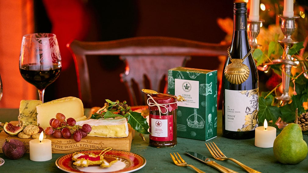Christmas gifts A table with festive wine and a cheese board. Christmas decorations are in the background.
